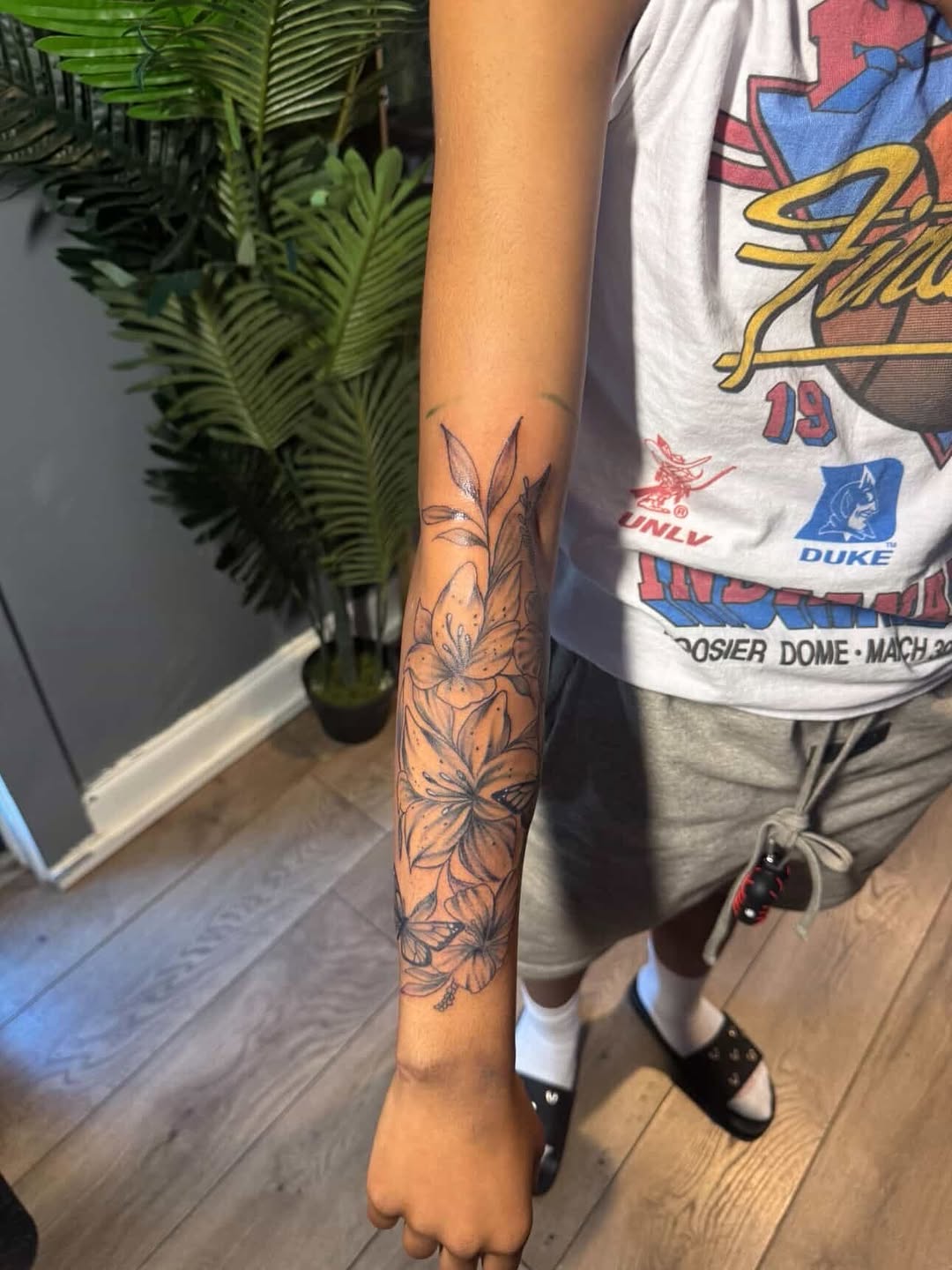 Lilies and butterflies fine line tattoo on the forearm by SpicyMvstardInkk