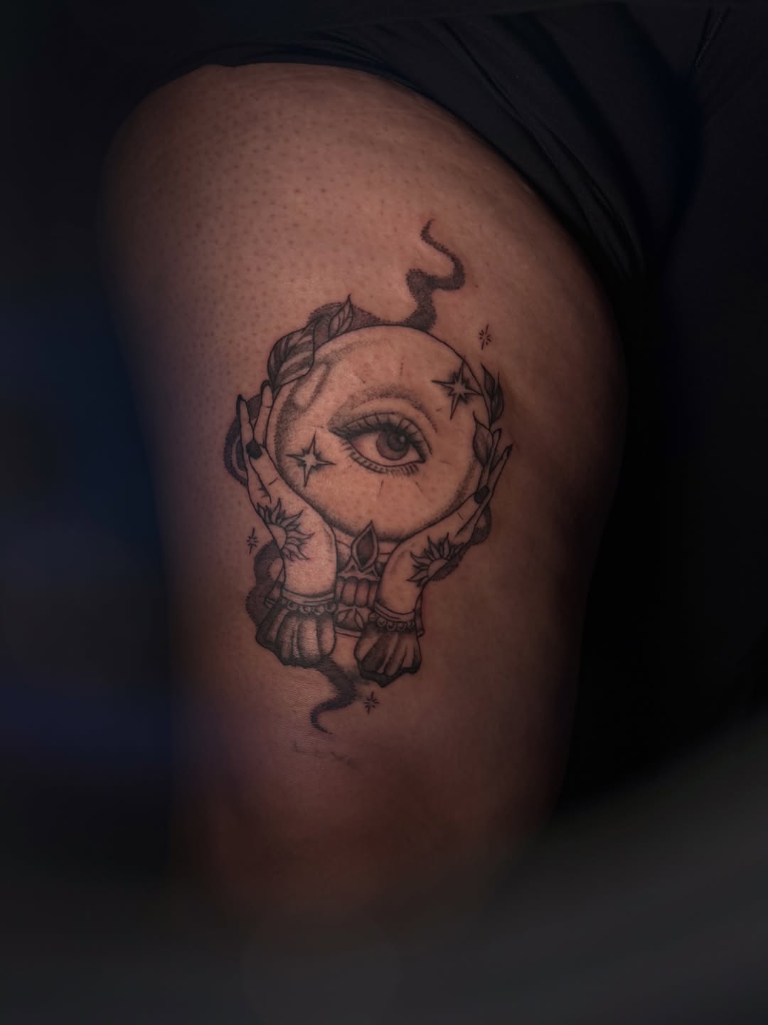 Crystal ball with eye and hands dotwork tattoo on the thigh by licensed charlotte tattoo artist