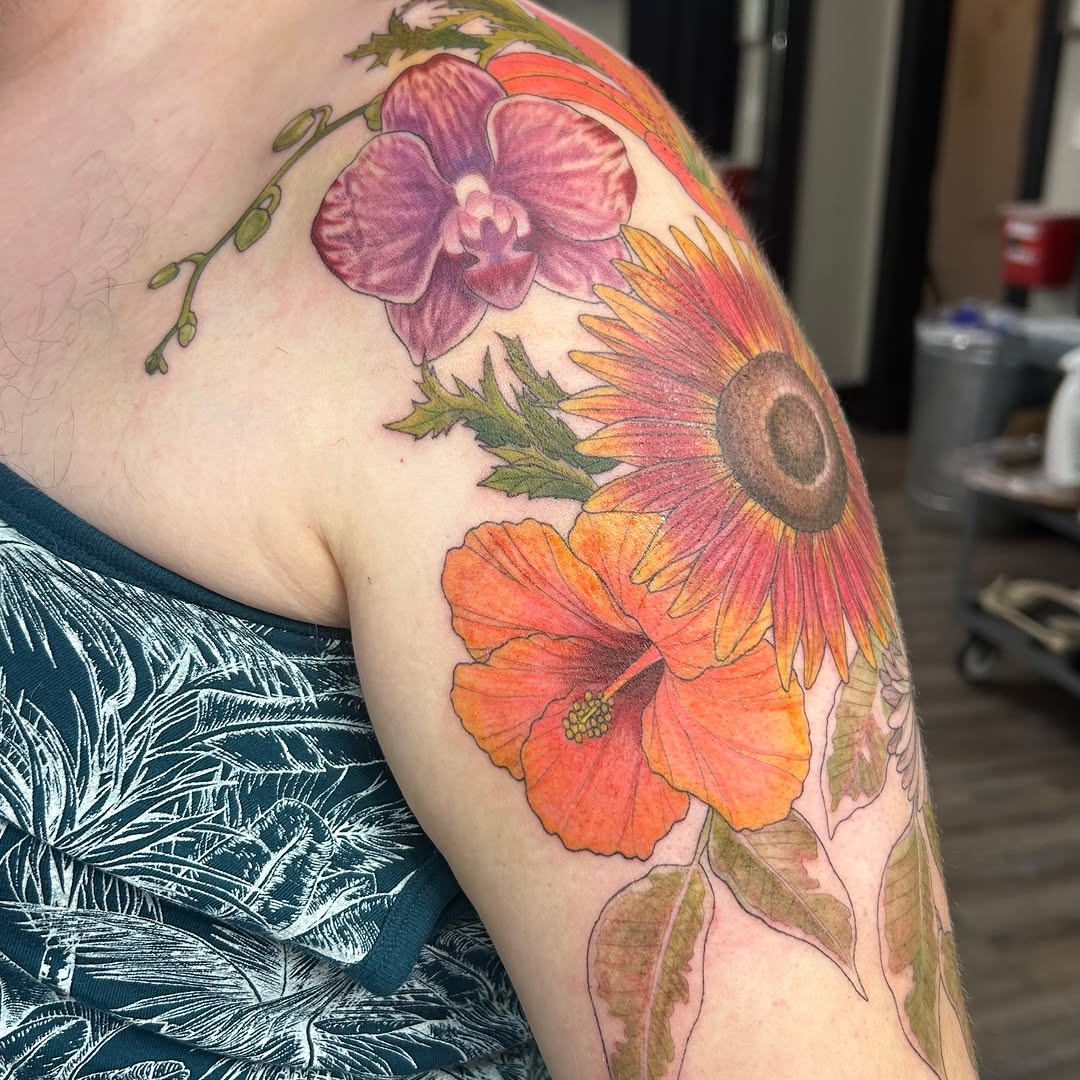 Tropical flowers watercolor tattoo on the shoulder by Kaylee