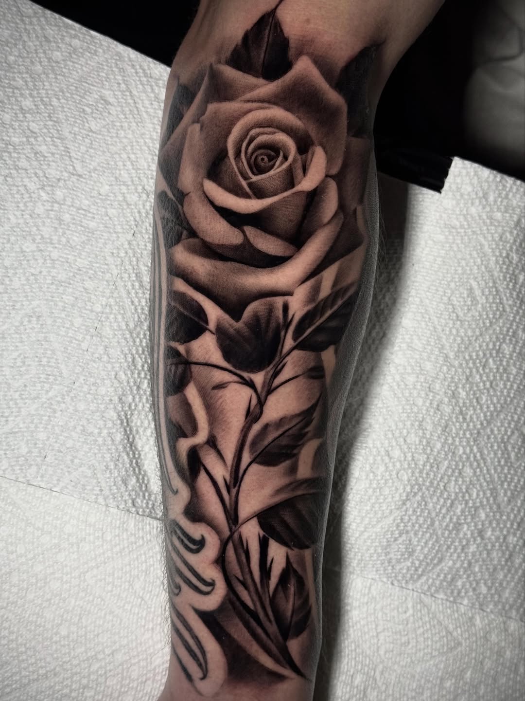 Rose and leaves dotwork tattoo on the forearm by Tony Garcia
