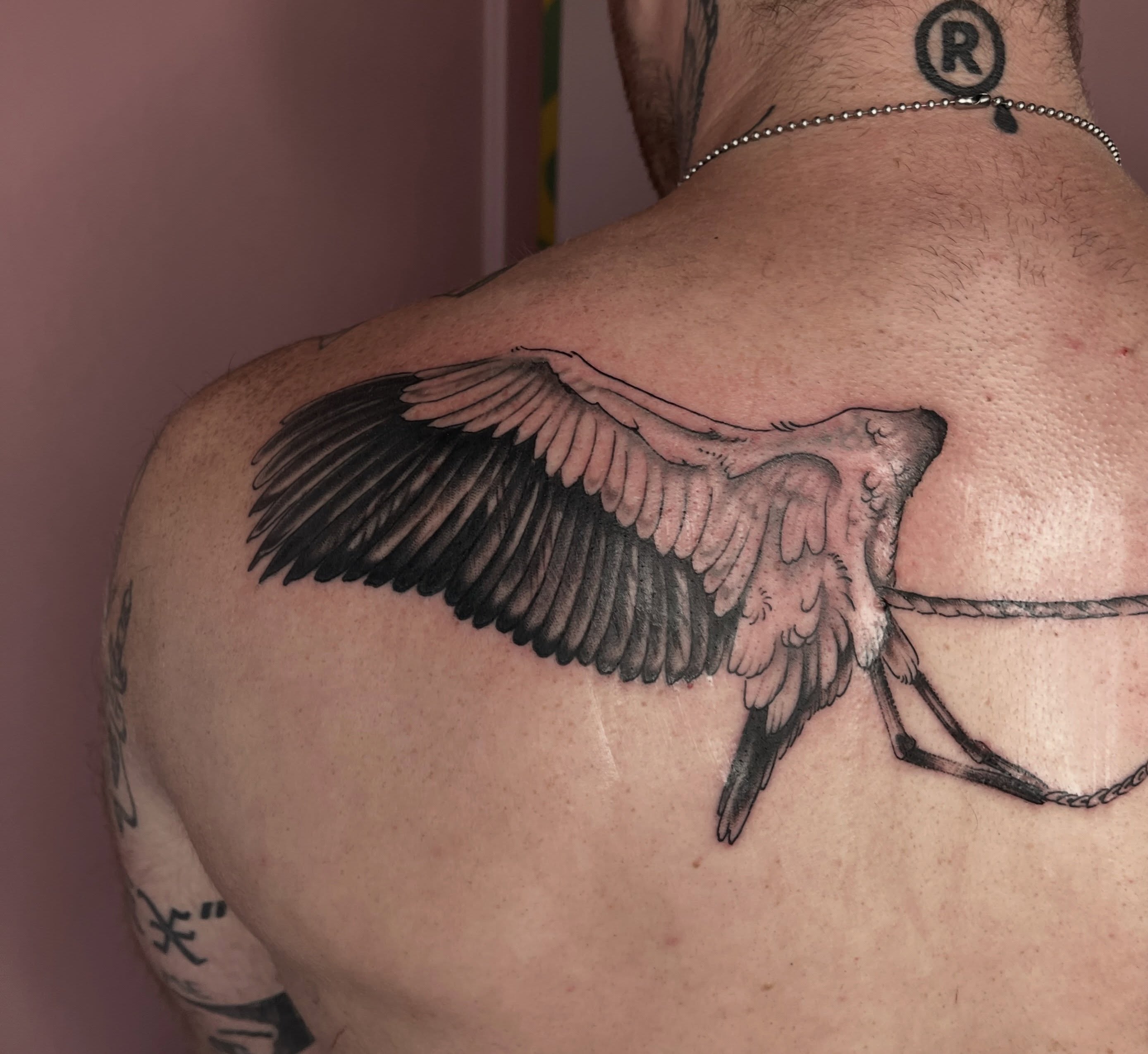 Bird black and grey tattoo on the back by Allyson Blessing Tattoos