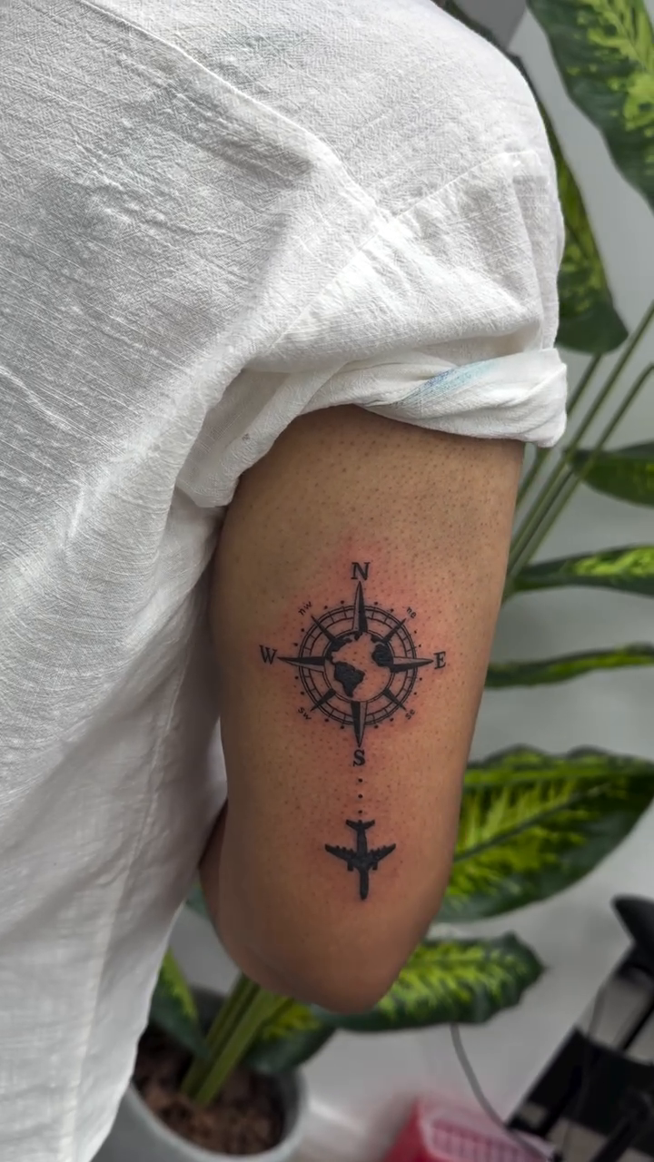 Compass with airplane realism tattoo on the forearm by Lina Valentina, New York, New York