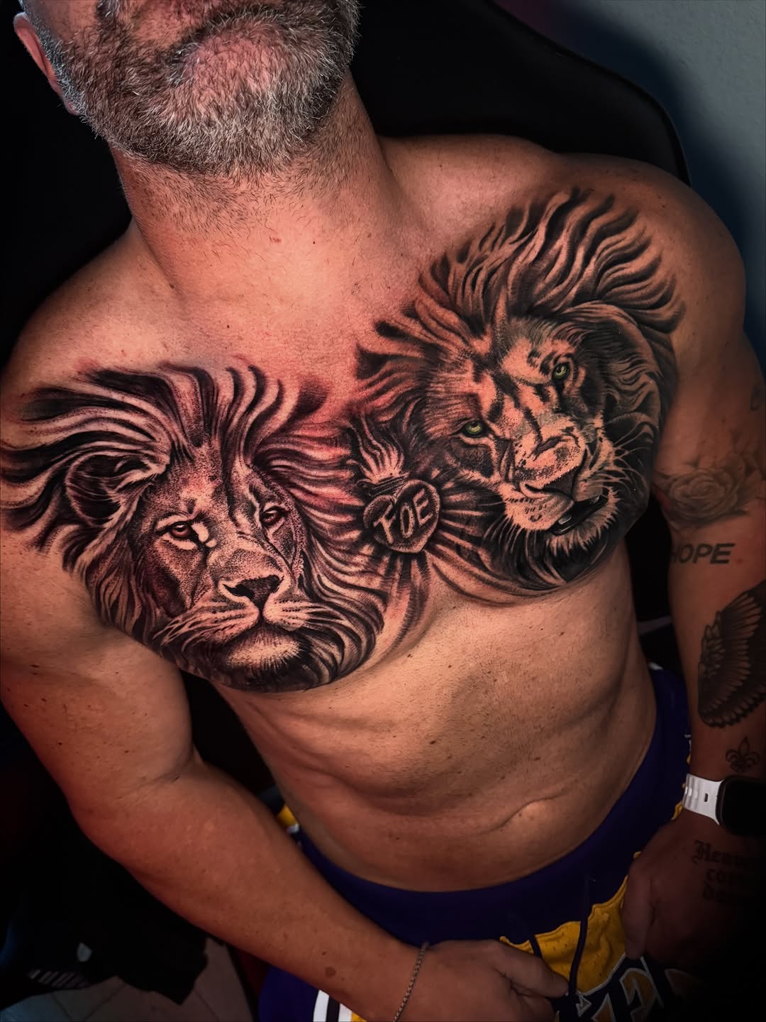 Two lions realism tattoo on the chest by Henry Fuentes