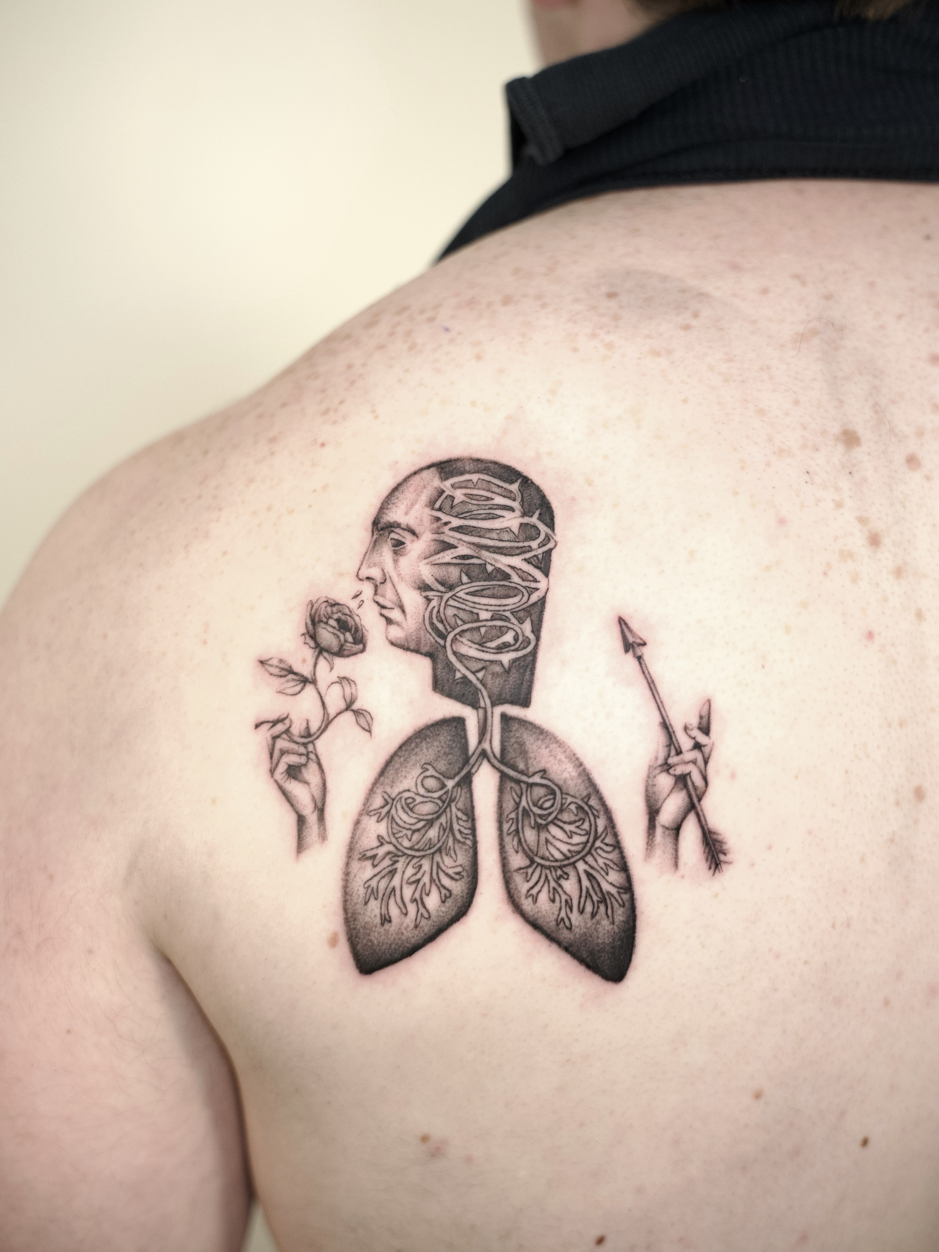 Human head with lungs and rose realism tattoo on the shoulder by @lovechasetattoo
