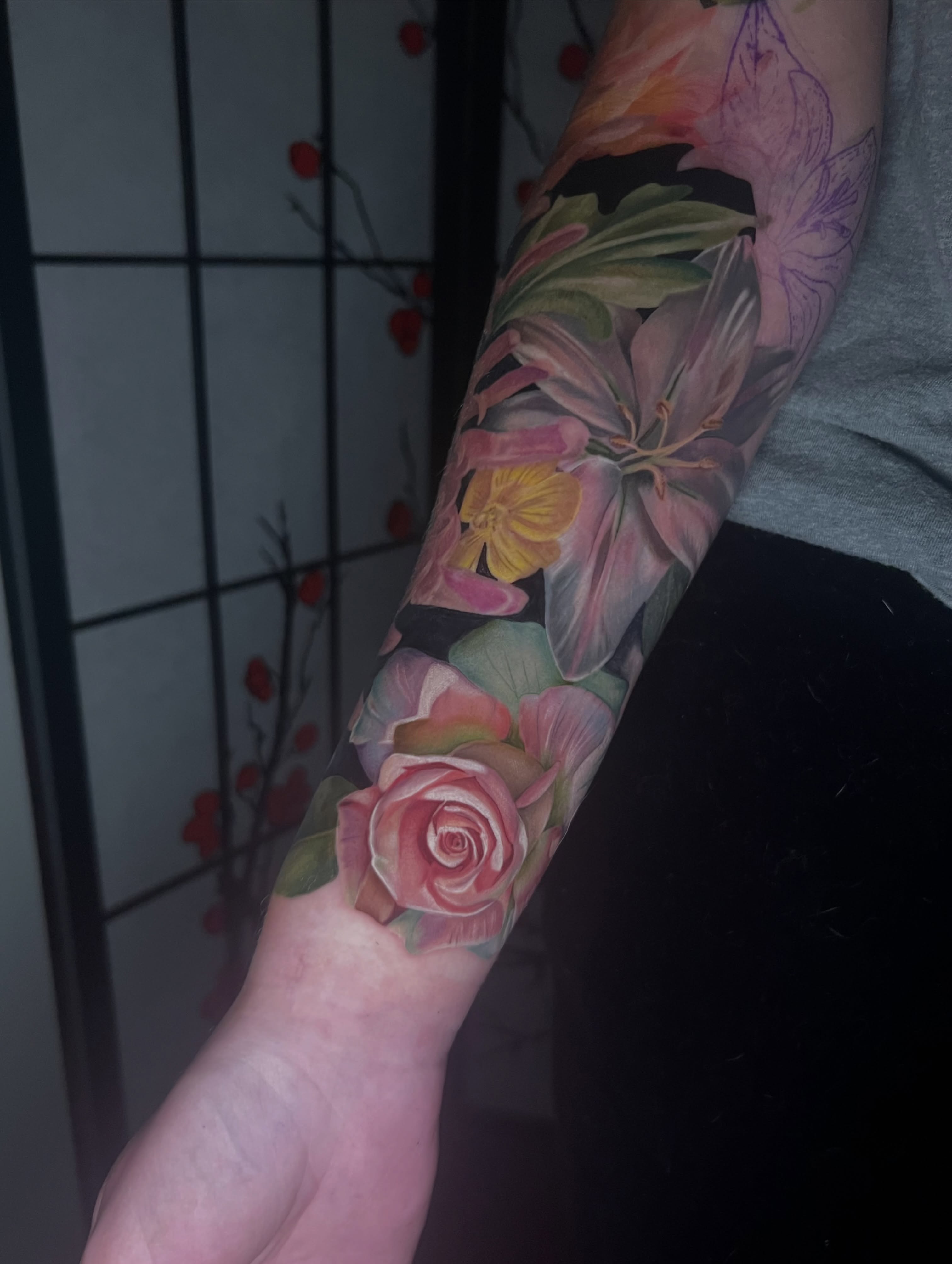 Floral bouquet realism tattoo on the forearm by Belle Halverson