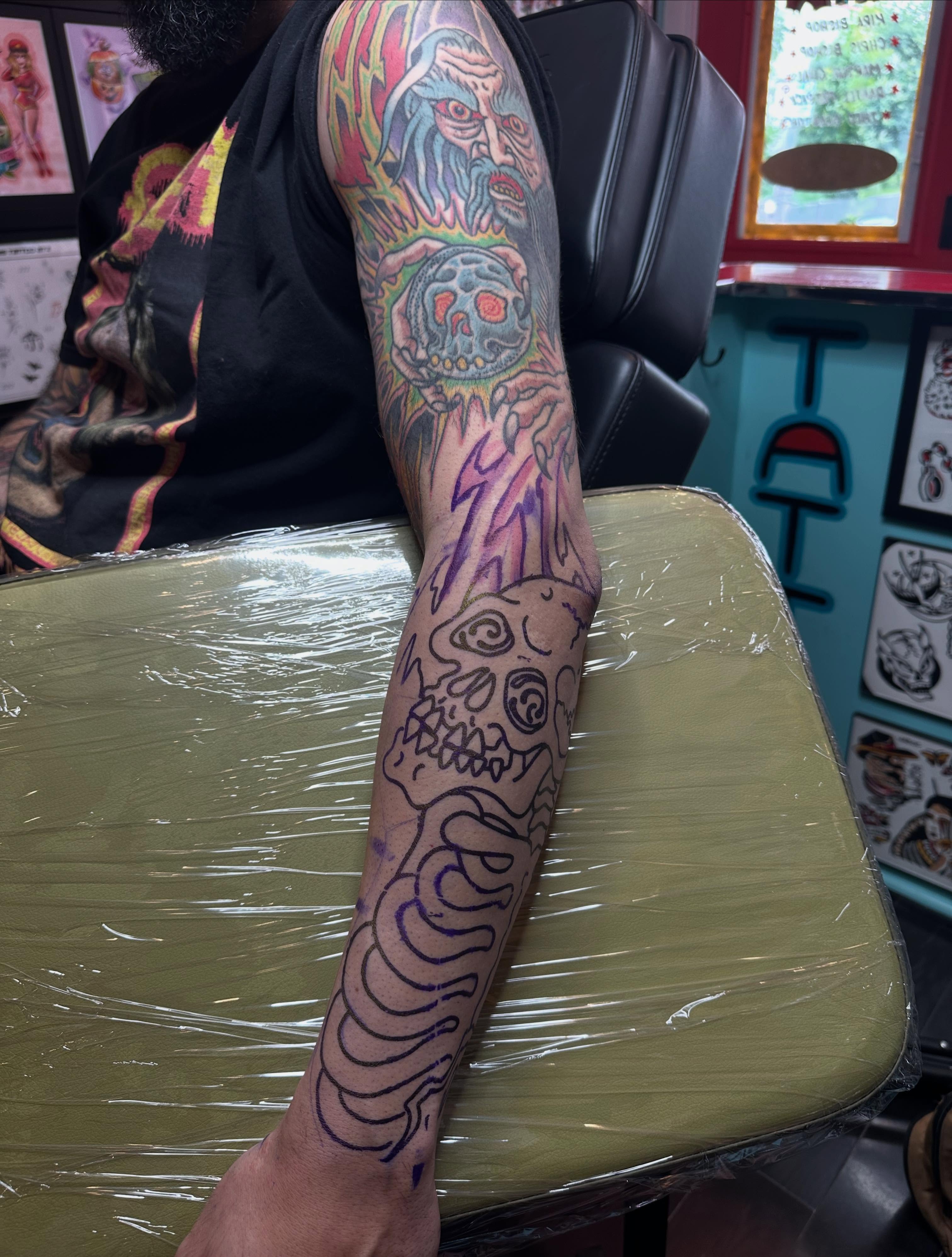 Skull and flame neo-traditional tattoo on the forearm by Chris Bishop