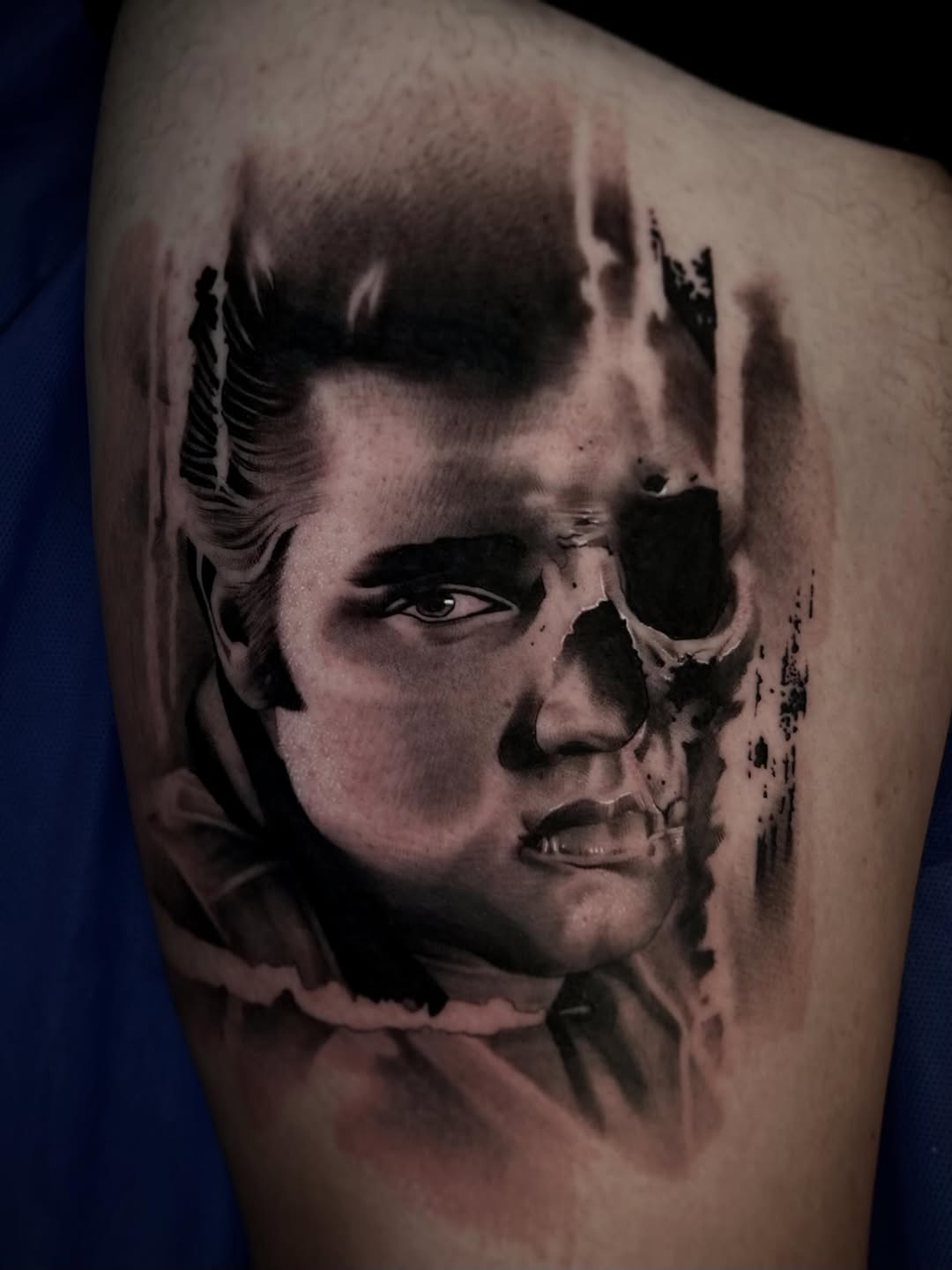 Elvis Presley portrait with skull realism tattoo on the shoulder by Dallas Corsmeier