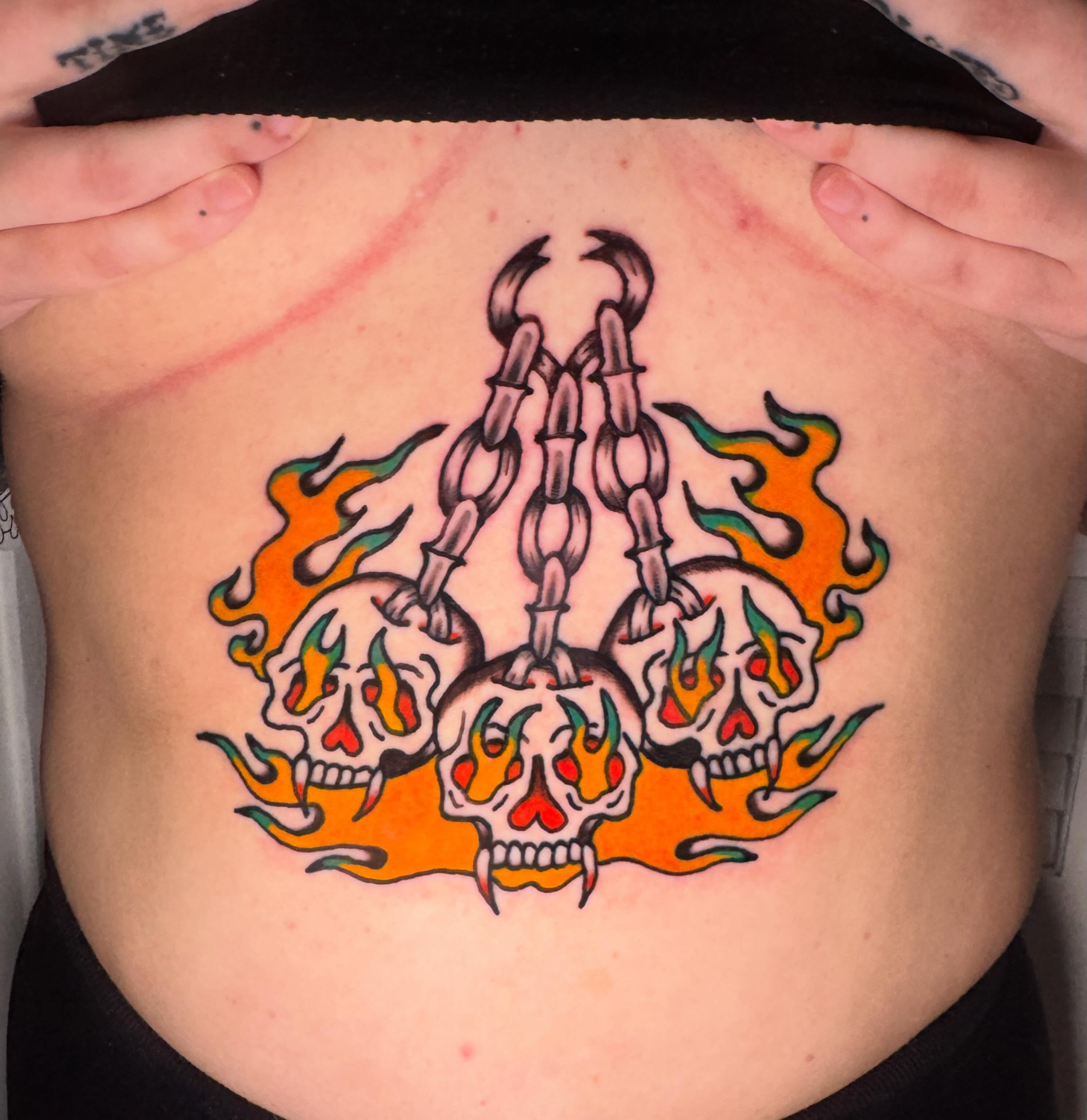 Flaming skulls American traditional tattoo on the ribs by Harrison ♠️