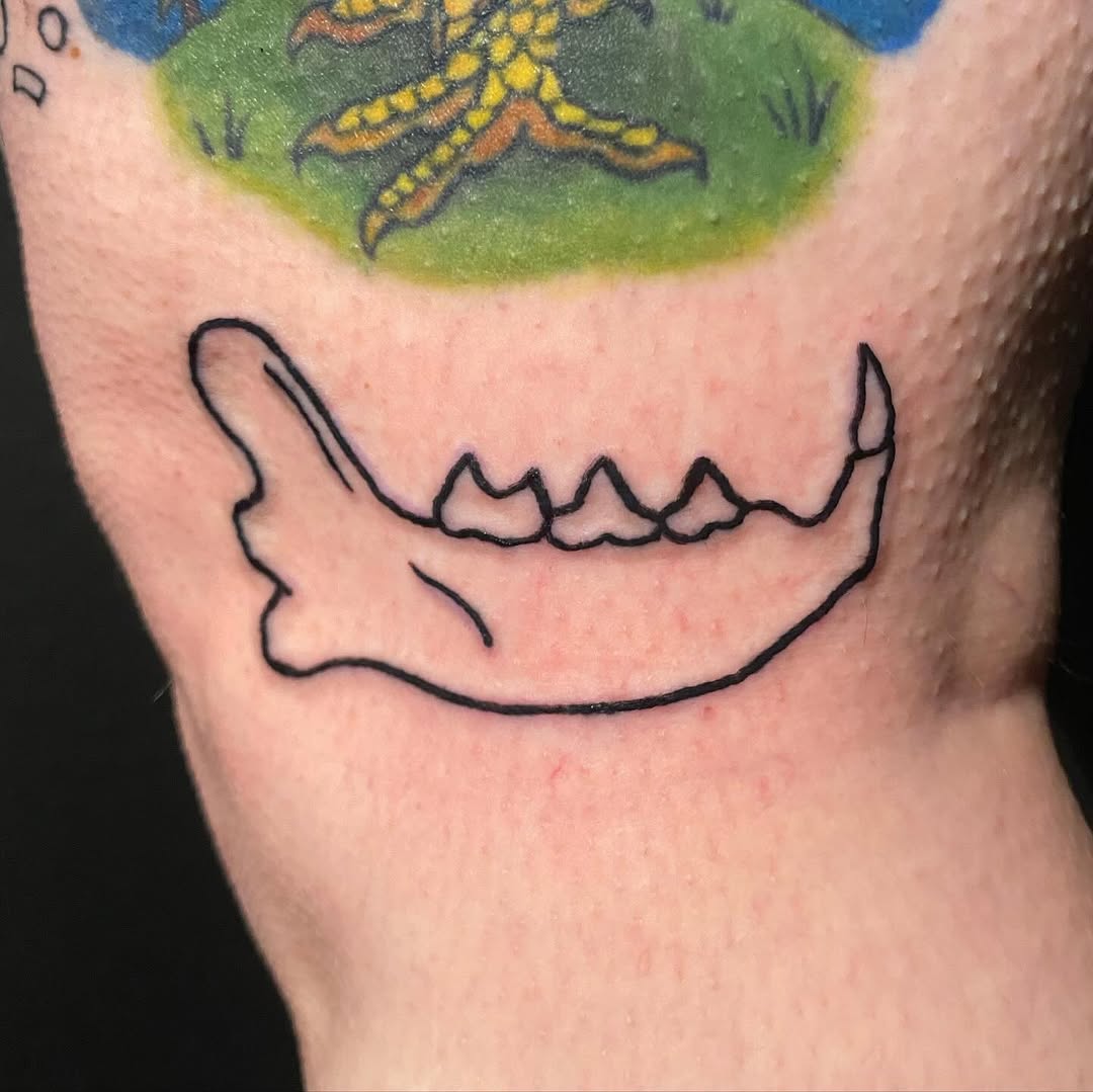 Animal jawbone outline minimalist tattoo on the forearm by ollie, Portland, Oregon