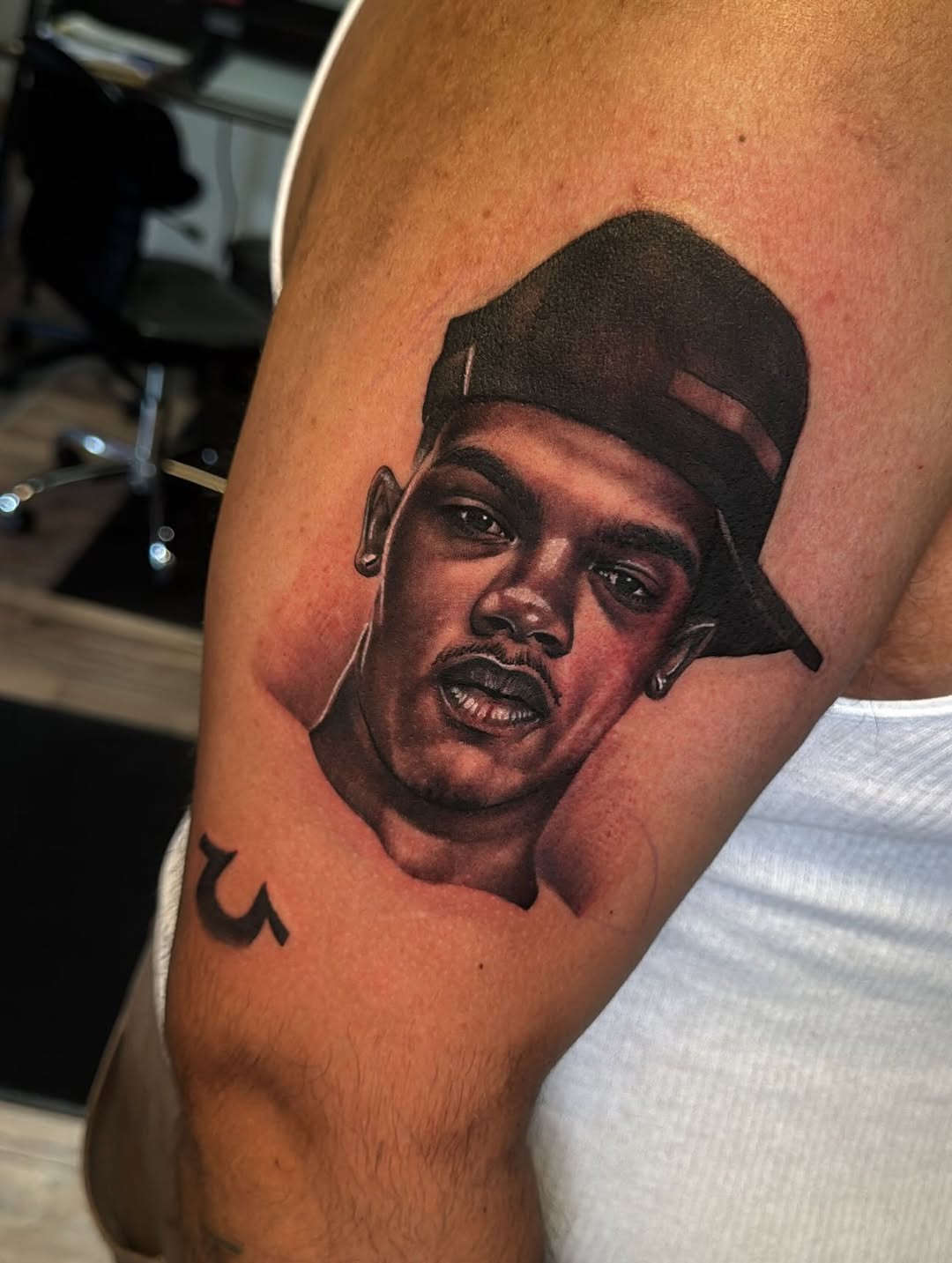 Realism tattoo on the upper arm by Cedric Fleming