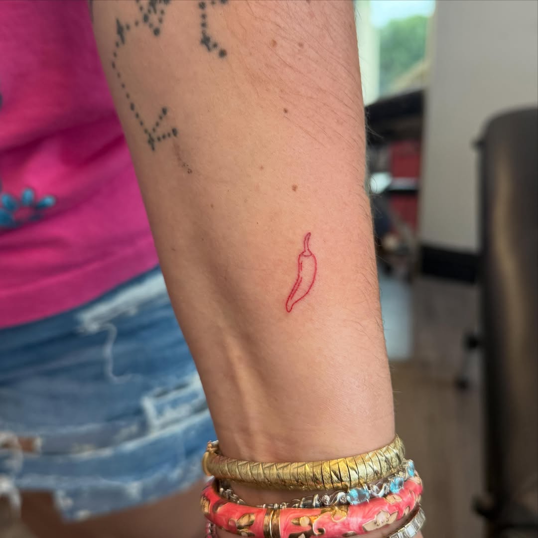 Chili pepper minimalist tattoo on the forearm by ✨olivia