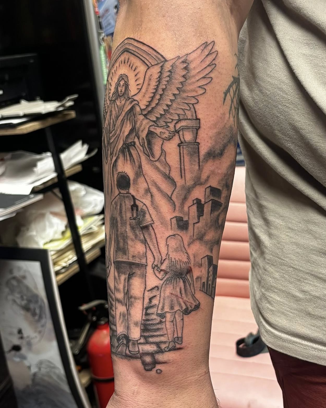 Angel guiding family realism tattoo on the forearm by Jeff Zuptich
