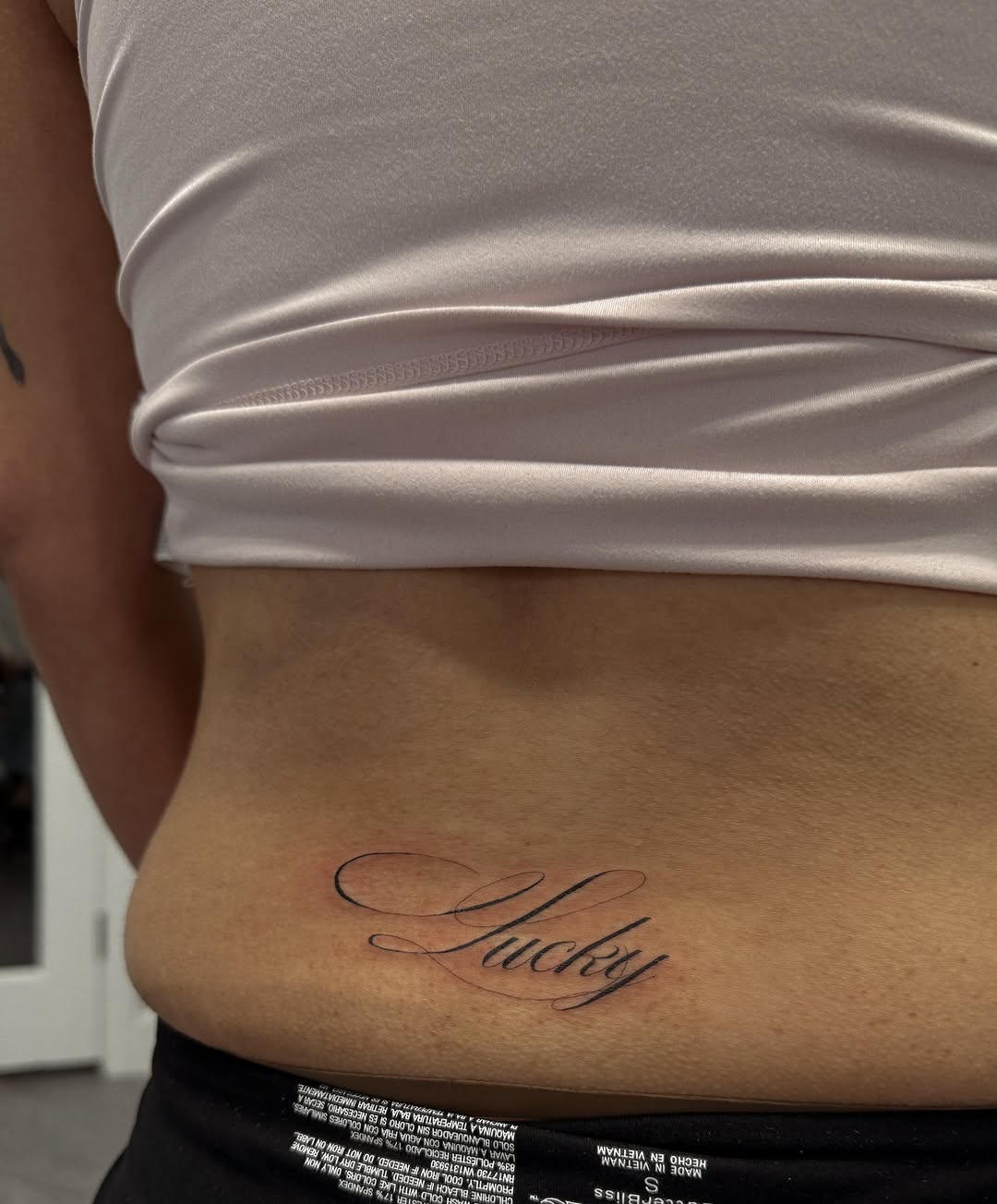 Script lettering tattoo on the torso by Jennifer Garcia R - Vegas tattoo artist