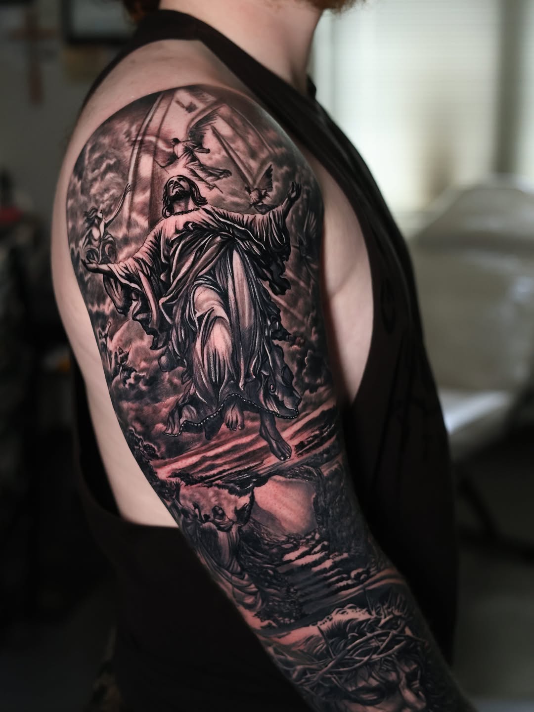 Jesus ascending with angels realism tattoo on the upper arm by Insight Ink Tattoo