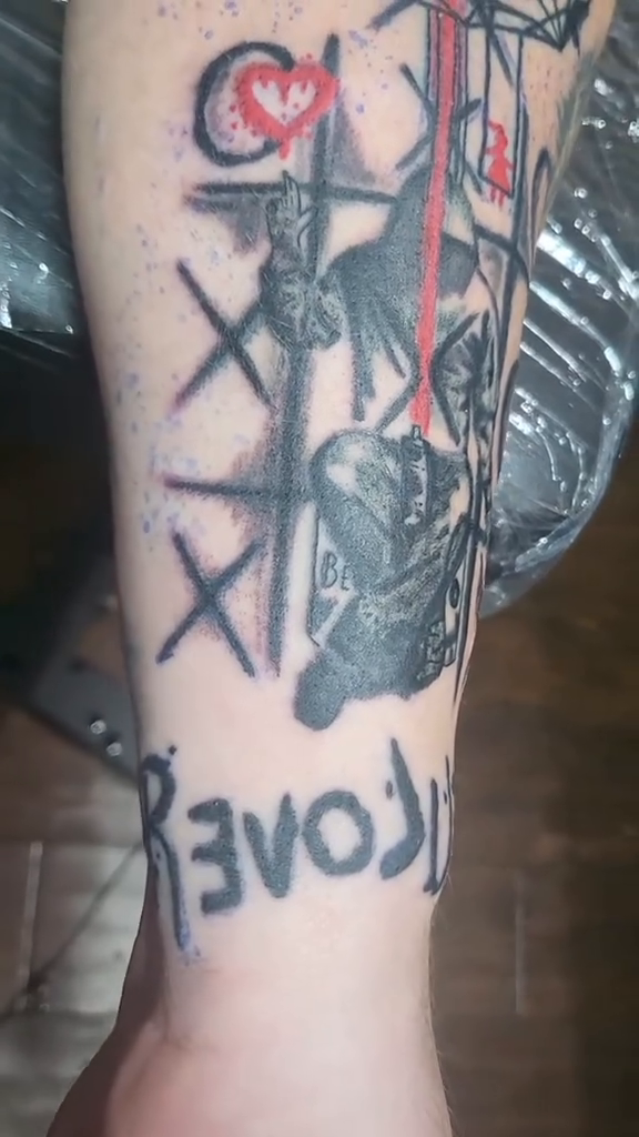 Dreamcatcher with tic-tac-toe and text ignorant tattoo on the forearm by Tanya Tattoota