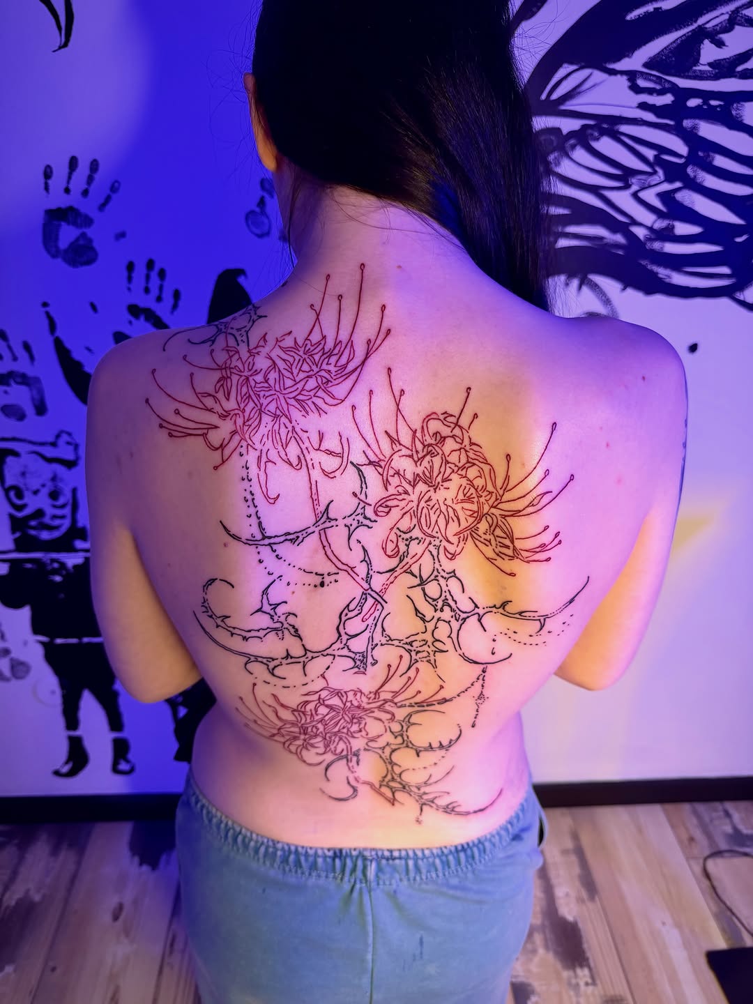 Spider lilies blackwork tattoo on the back by K Valentine