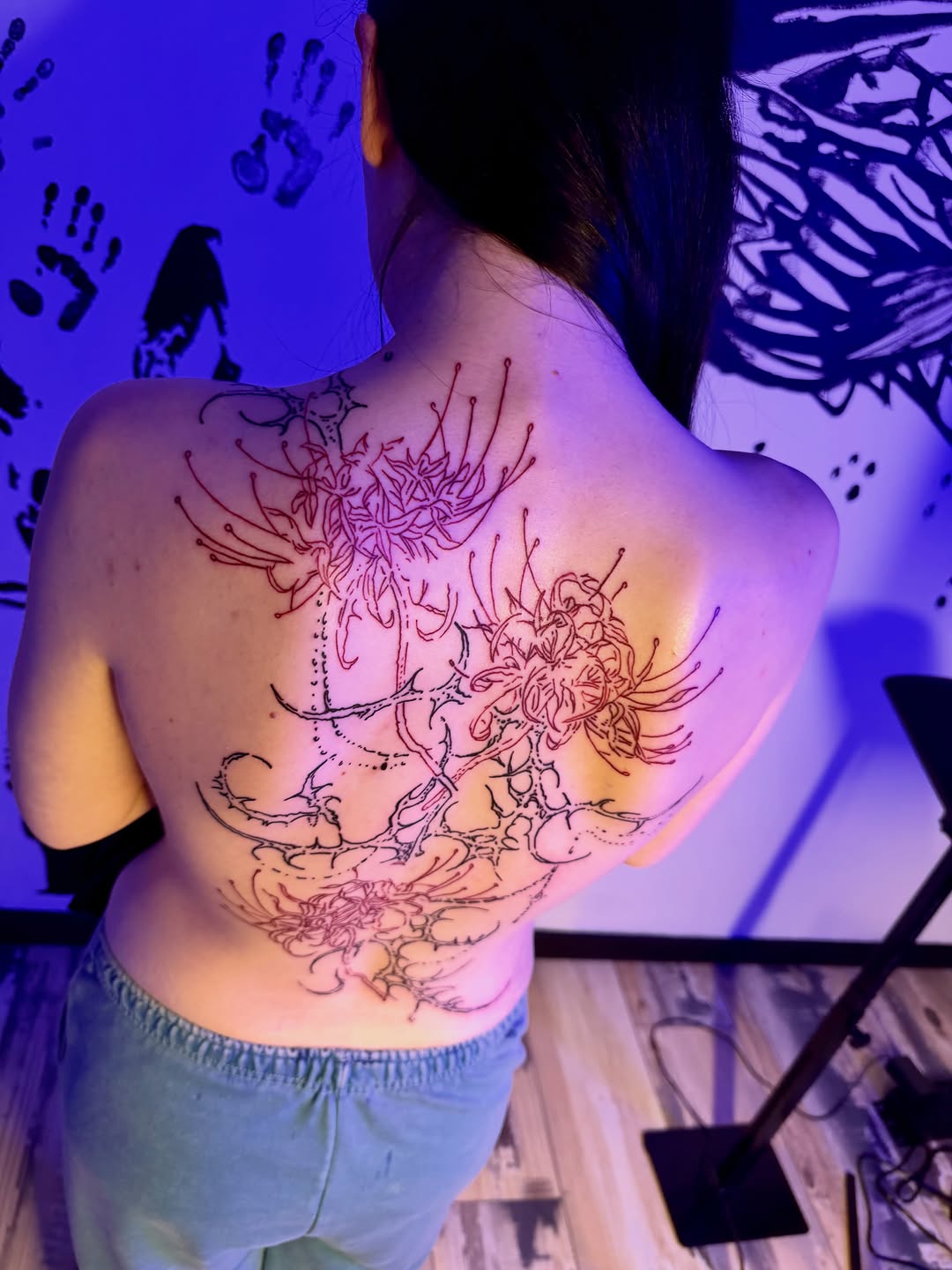 Spider lilies blackwork tattoo on the back by K Valentine