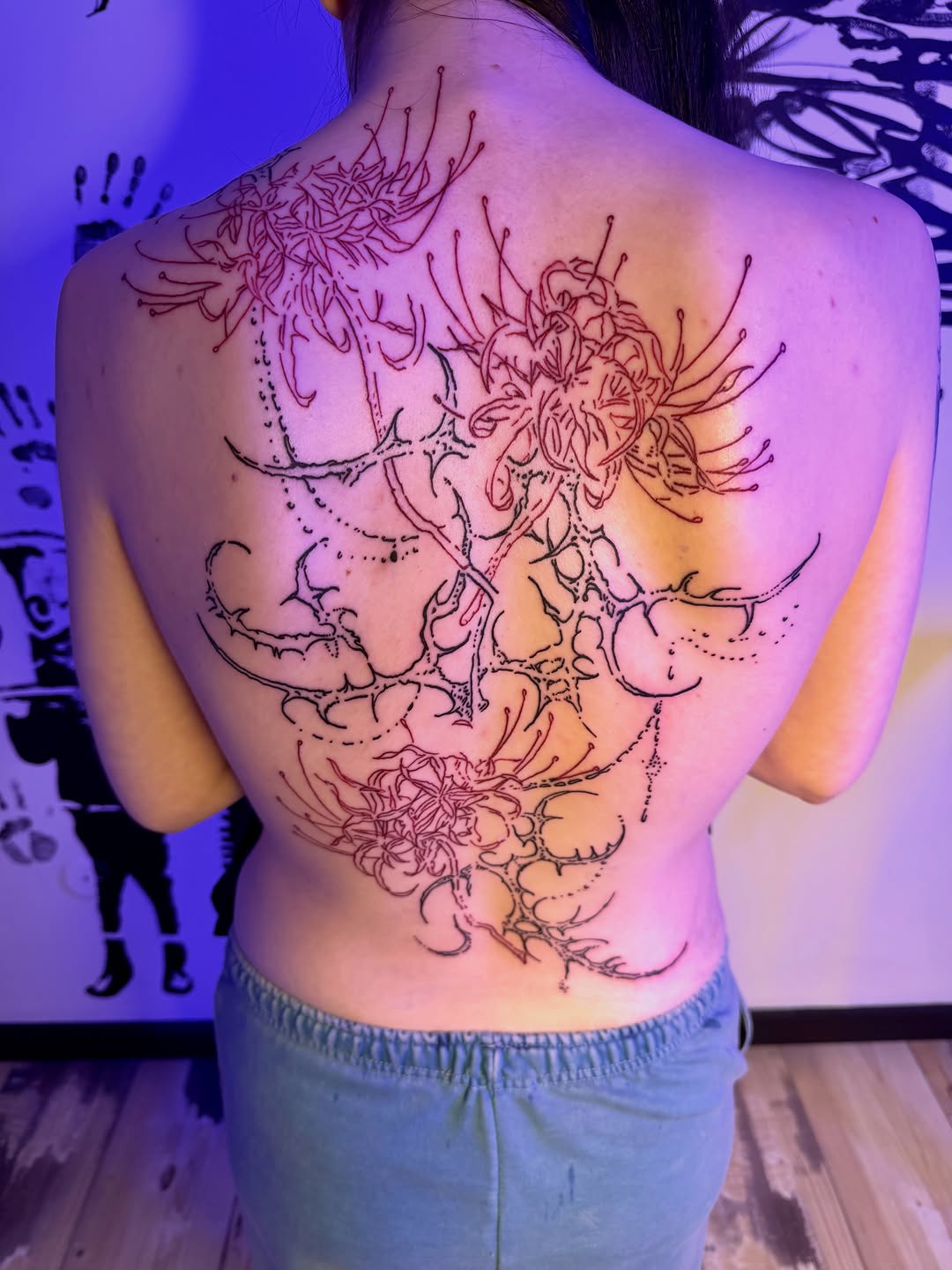 Spider lilies on back blackwork tattoo on the back by K Valentine