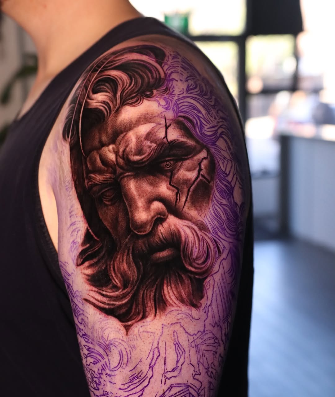 Bust of a man surrealism tattoo on the upper arm by Naomi Burke, New Westminster, British Columbia