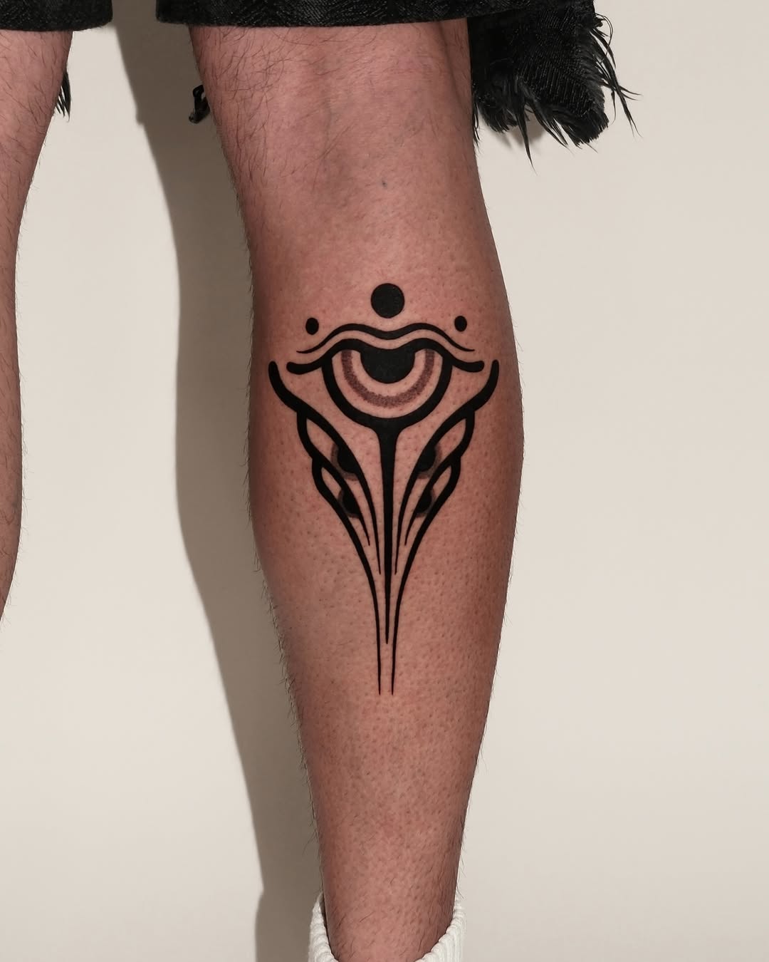 Stylized eye cyber sigilism tattoo on the calf by Fisher Man