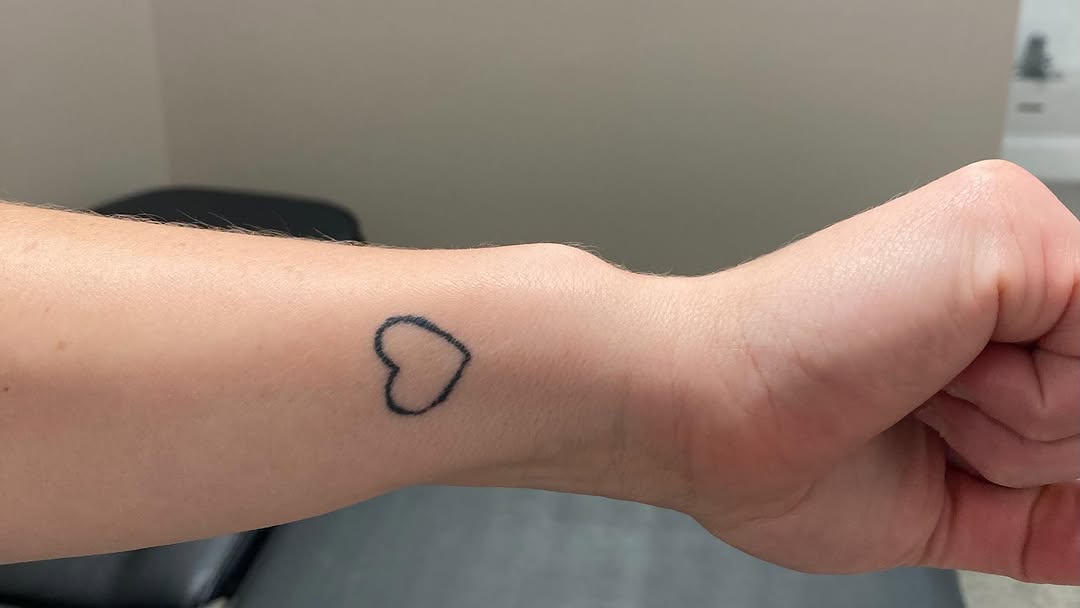 Outline heart minimalist tattoo on the forearm by Timothy Murtaugh