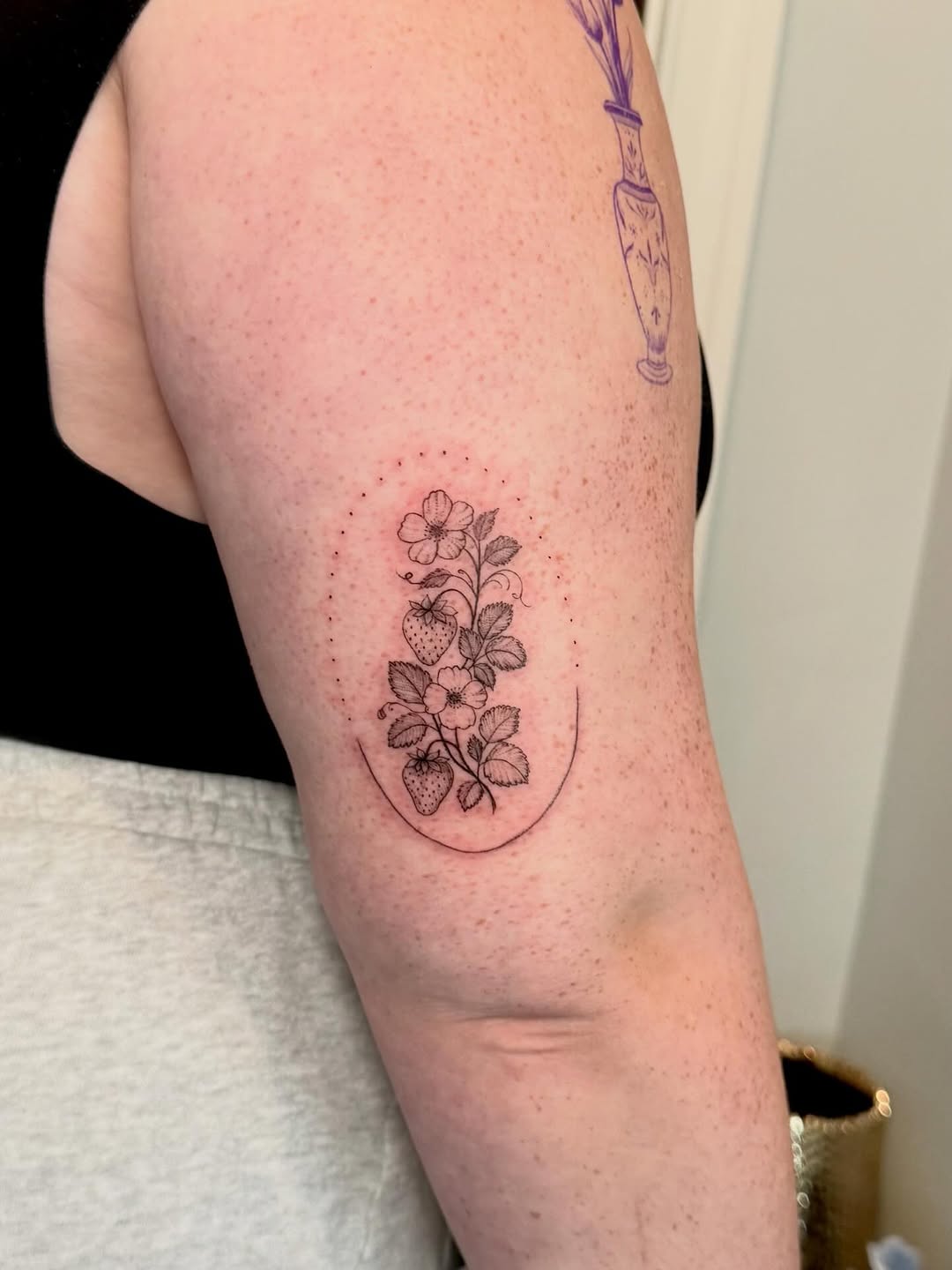 Strawberry plant with flowers minimalist tattoo on the forearm by Ana Blatt