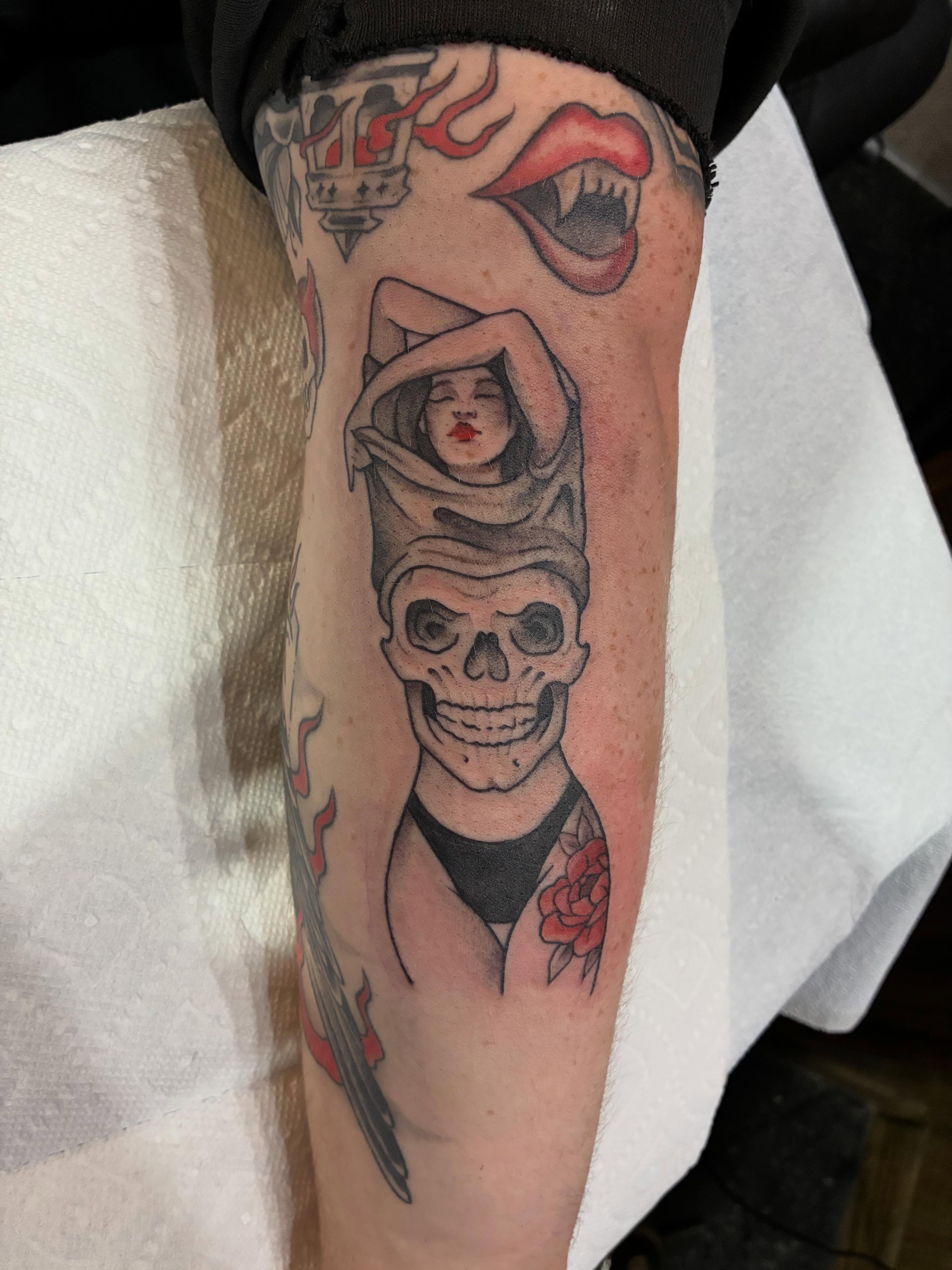 Woman with skull American traditional tattoo on the forearm by Natalie Spuhler