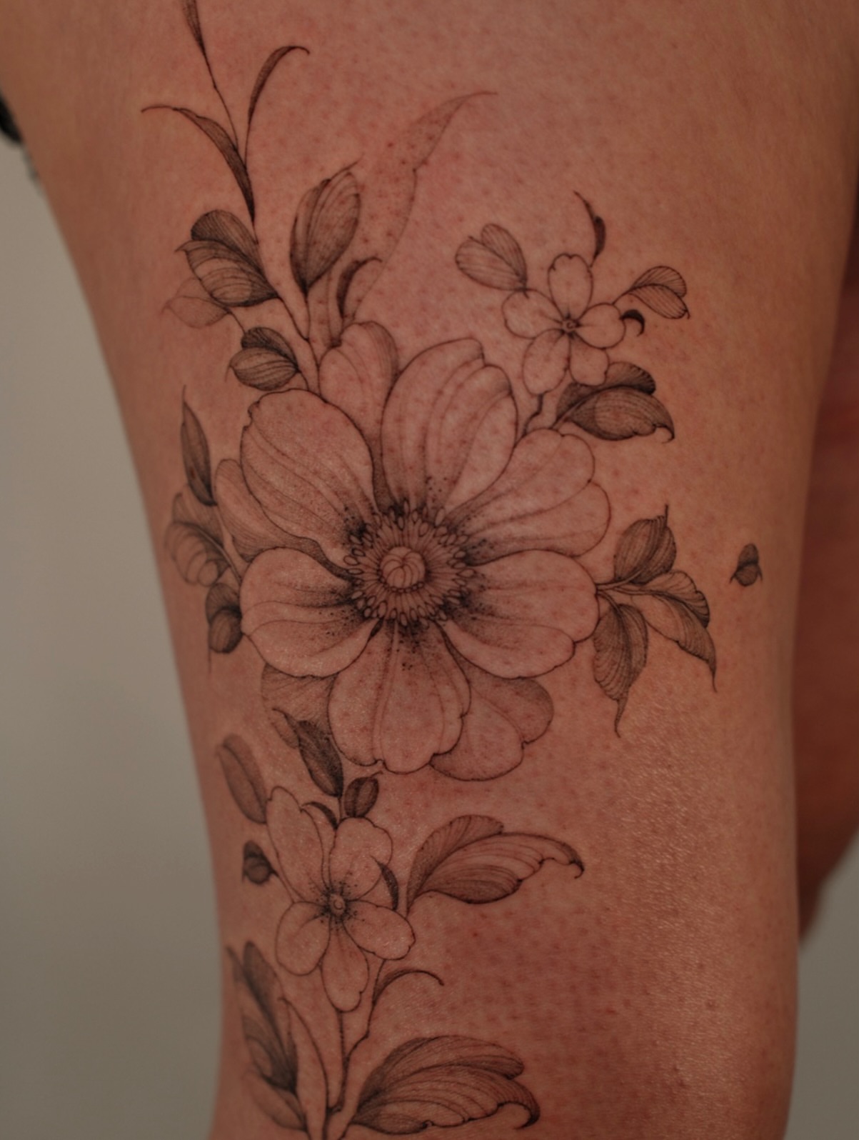 Floral bouquet black and grey tattoo on the leg by LORIE π€ Floral Tattoo Artist, Los Angeles, California