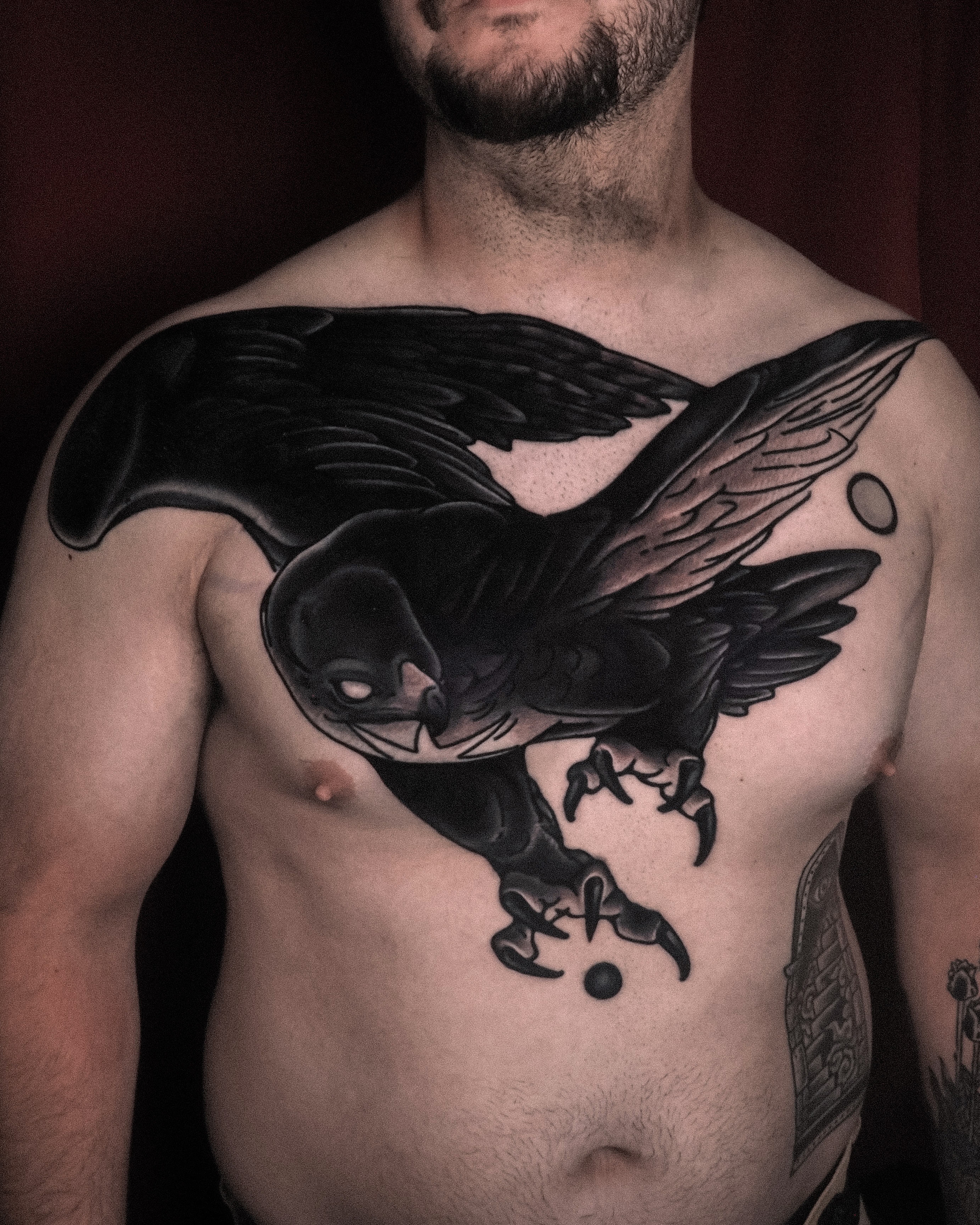 Raven black and grey tattoo on the chest by Last Year Of Disaster