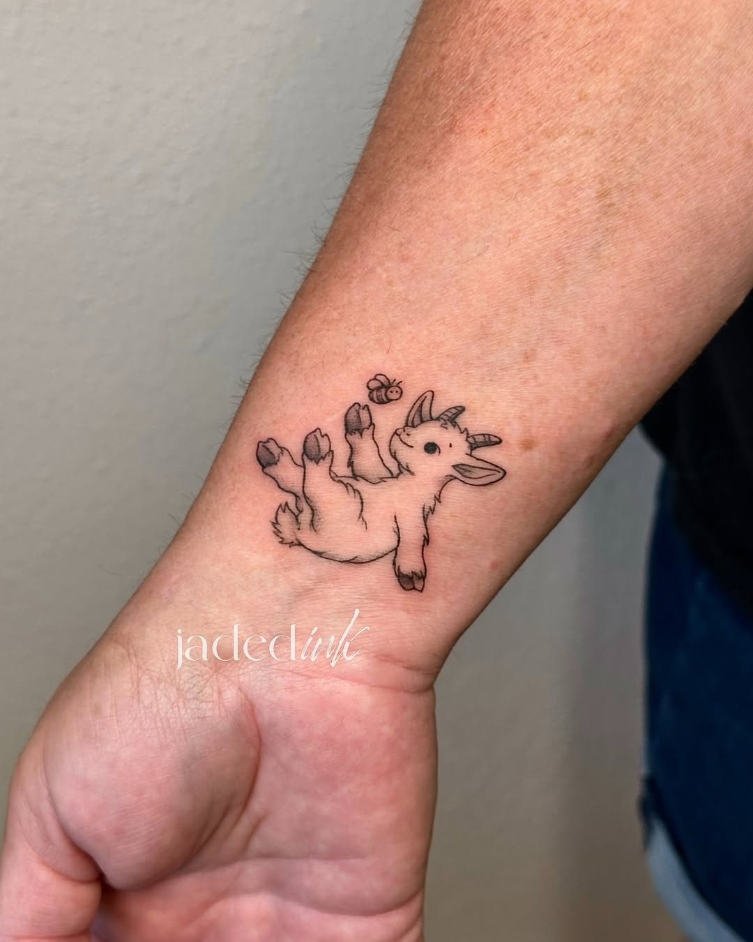 Baby goat and bee fine line tattoo on the forearm by 𝑱𝒂𝒅𝒆𝒅 𝑰𝒏𝒌 𝑷𝒆𝒓𝒎𝒂𝒏𝒆𝒏𝒕 𝑴𝒂𝒌𝒆𝒖𝒑 & 𝑻𝒂𝒕𝒕𝒐𝒐