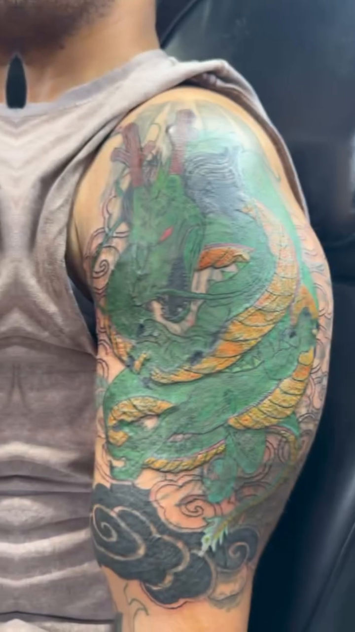 Green dragon sleeve Japanese tattoo on the upper arm by Jones Eric