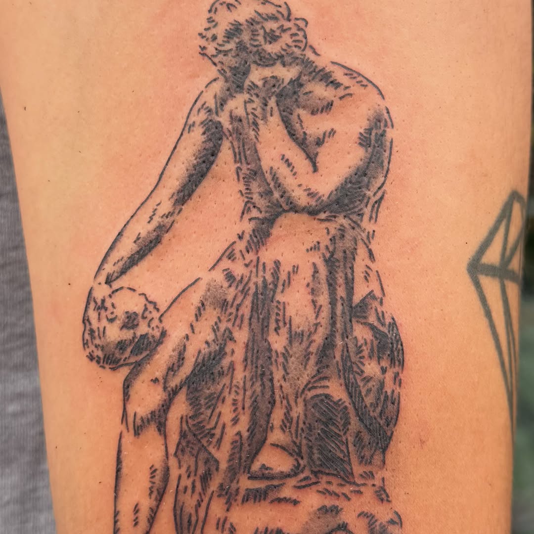 Statue of woman black and grey tattoo on the forearm by Kieara West