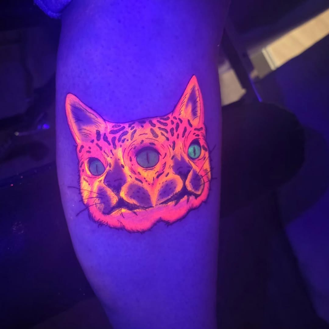 Three-eyed cat head dark art tattoo on the forearm by Karley Michelle Moody