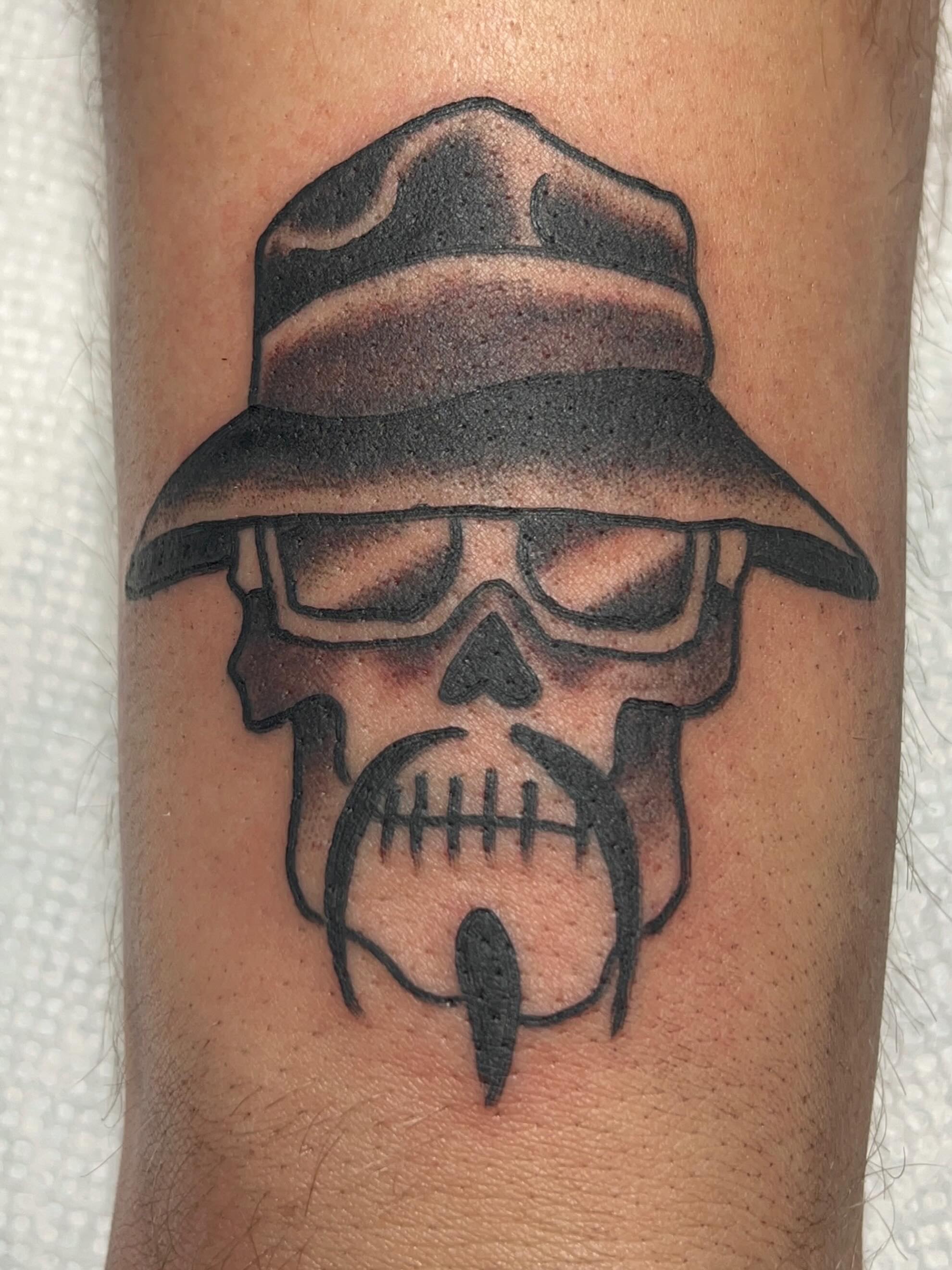 Skull wearing hat black and grey tattoo on the forearm by Casey Lewis - Tattoo Artist, Cleveland Ohio