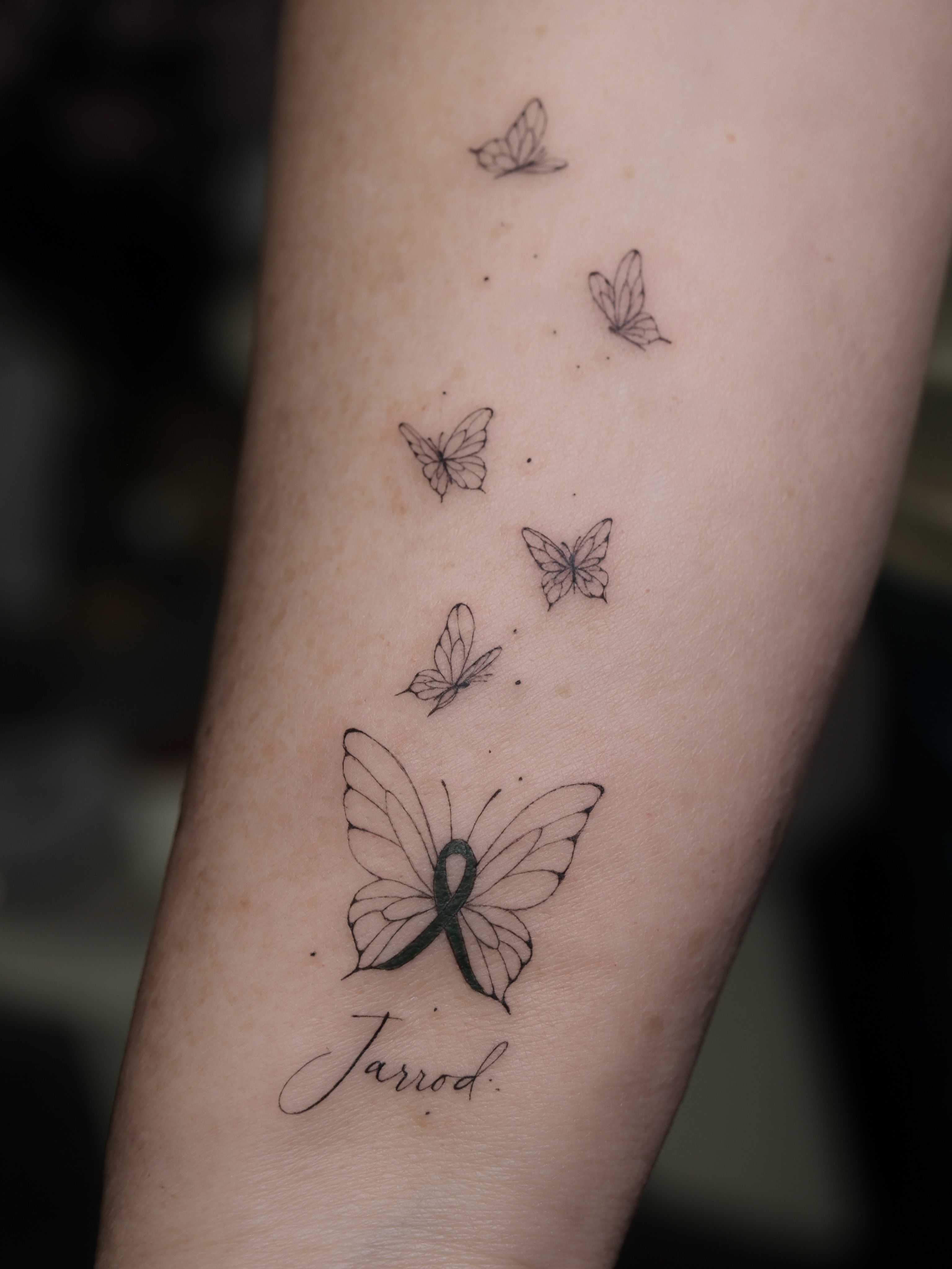 Butterfly fine line tattoo on the forearm by Victoria