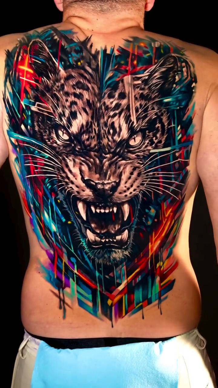 Tiger face with abstract geometric elements watercolor tattoo on the back by Israel De Jesus Legonier Aguliera