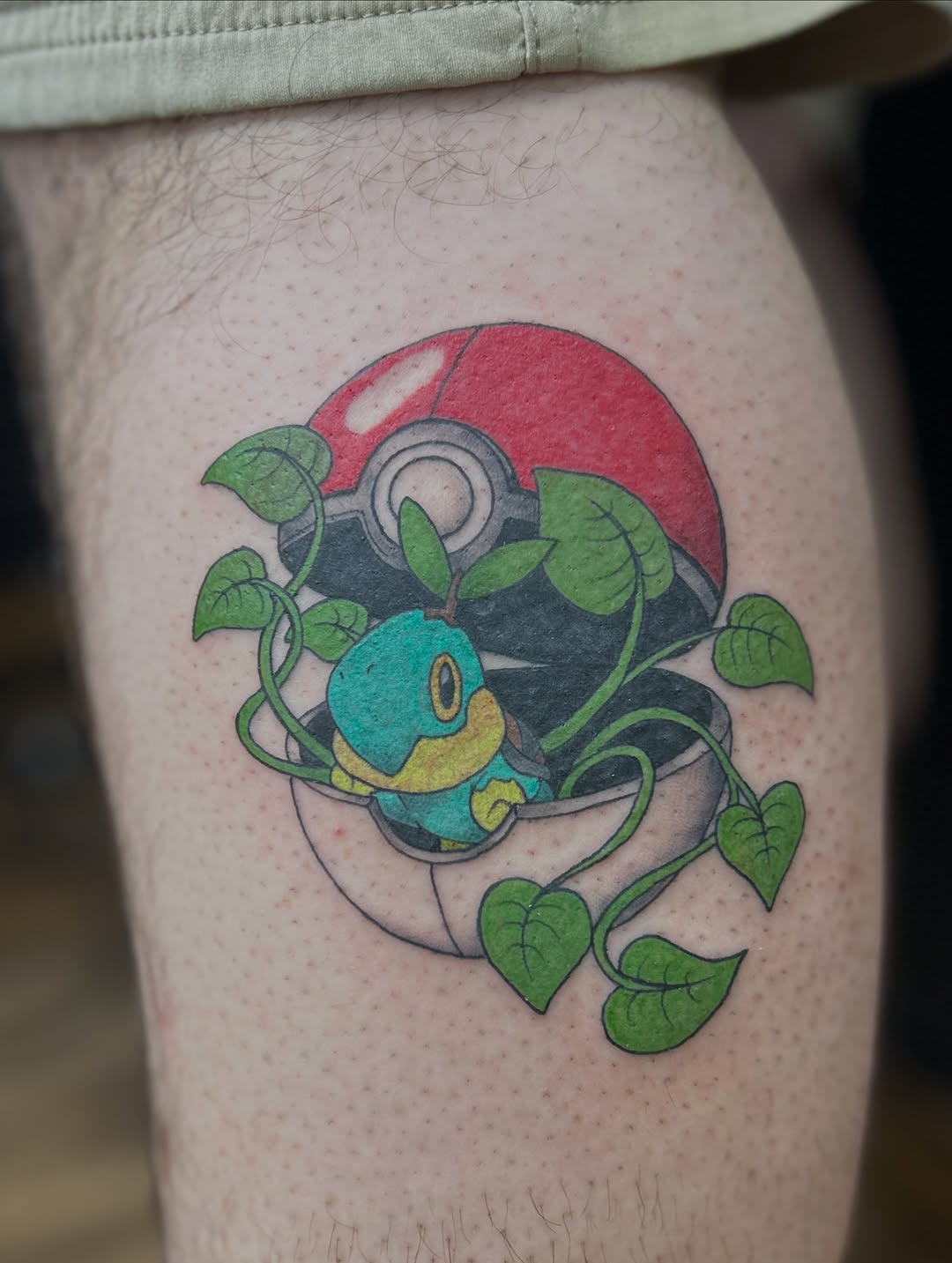 Pokemon and Pokeball with vines new school tattoo on the thigh by Abby Camacho - Tattoo Artist and Piercer โจ๐