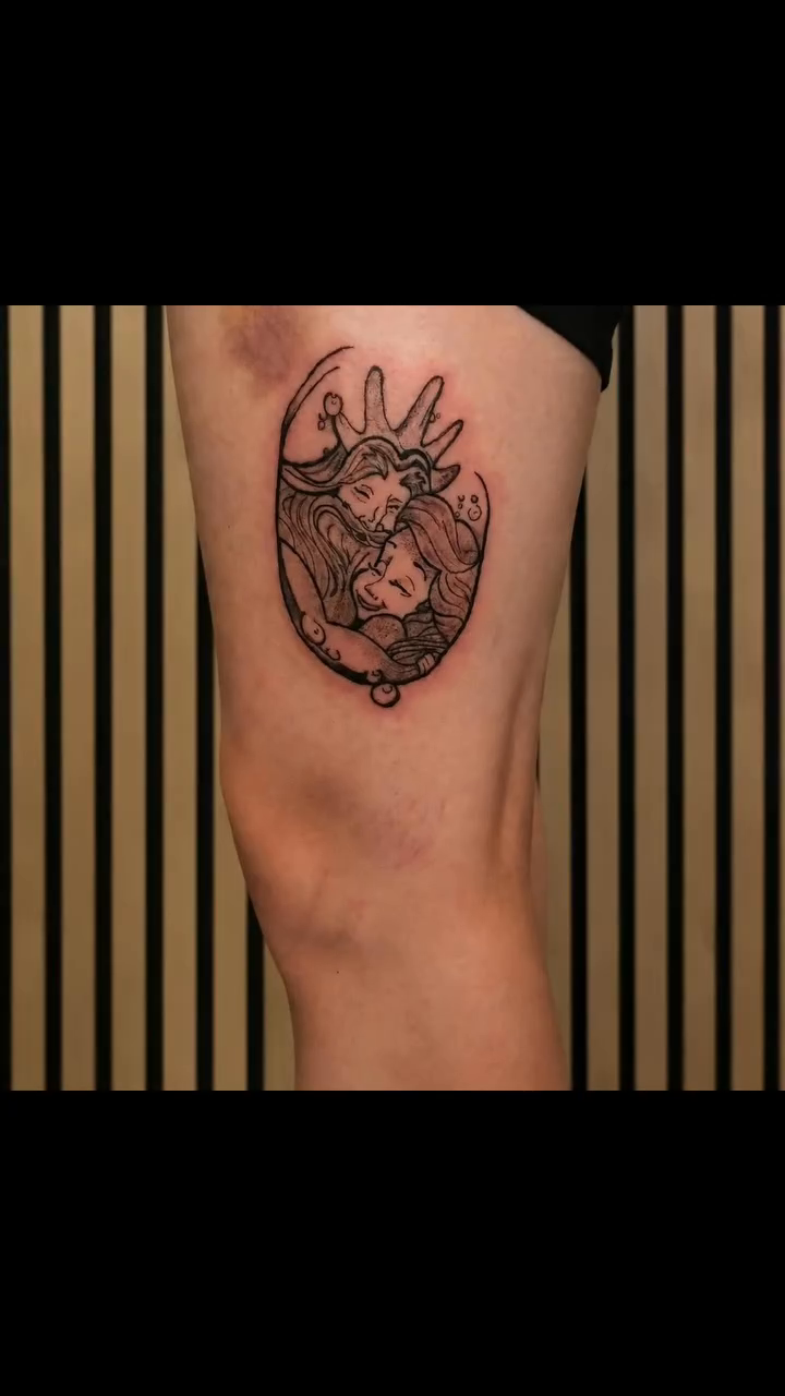 Ariel and Prince Eric embracing fine line tattoo on the forearm by Artful Ink