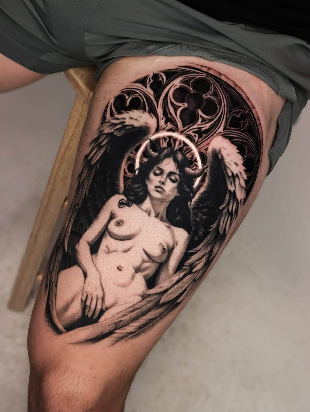Fallen angel with horns and halo realism tattoo on the thigh by Jeff Reindel