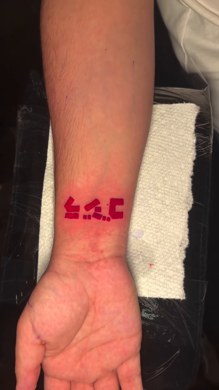 Japanese characters on wrist tattoo on the forearm by @getmoneetattz