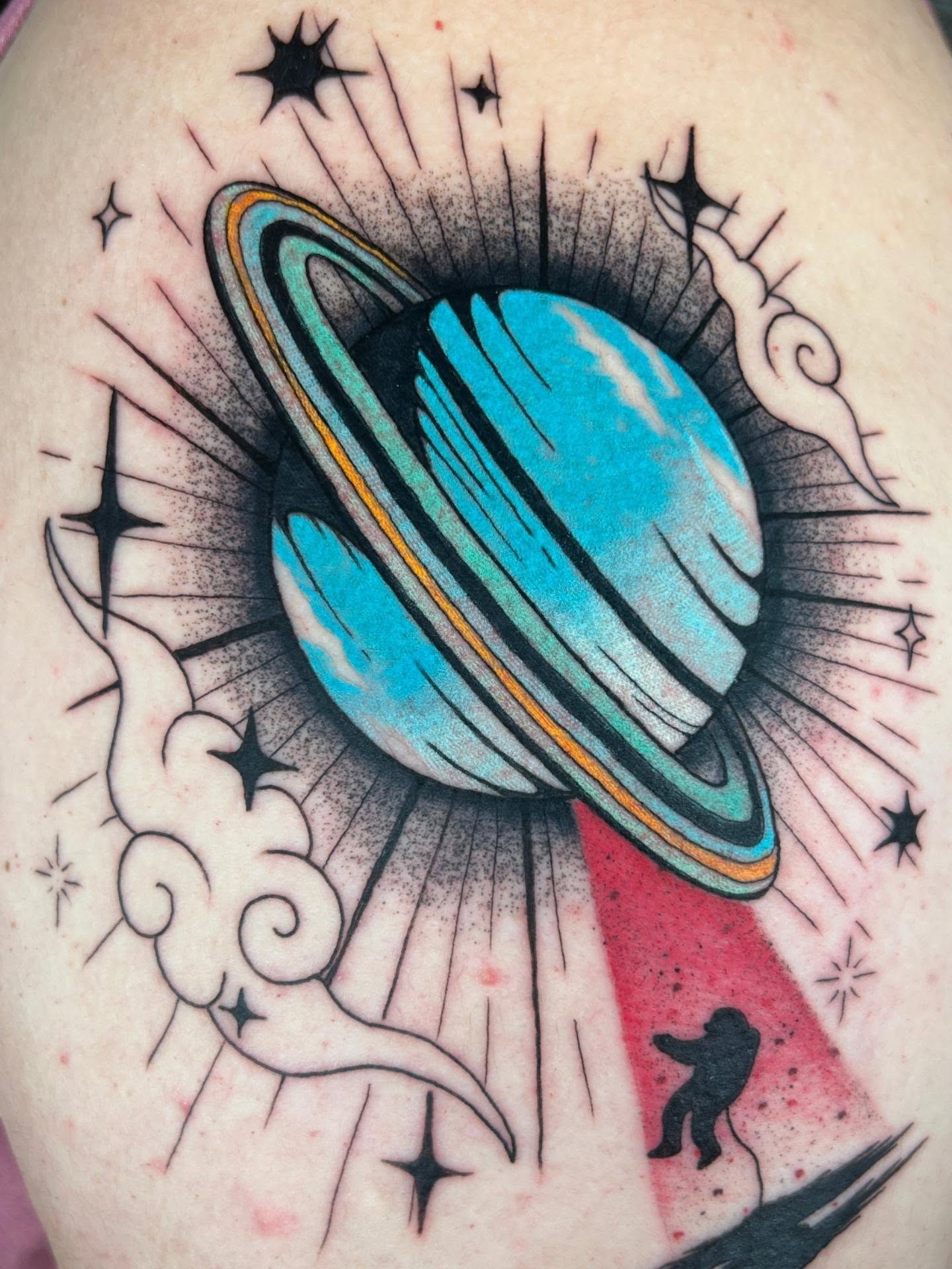 Saturn American traditional tattoo on the upper arm by Chloe Marie