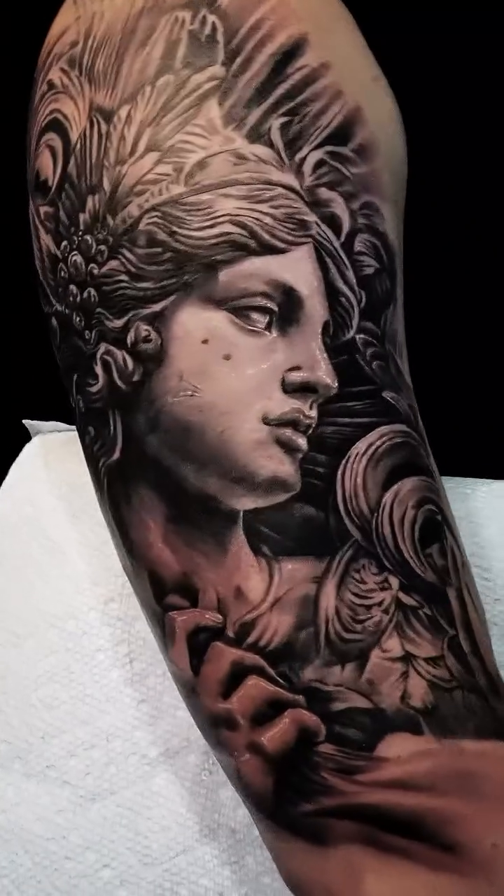 Realism tattoo on the upper arm by Alberto Marrero