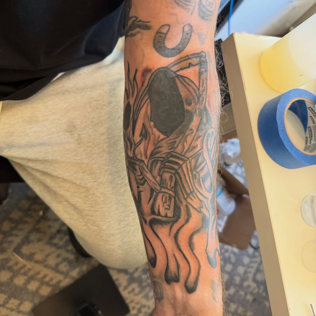 Grim reaper with scythe dark art tattoo on the forearm by Addison Bruce