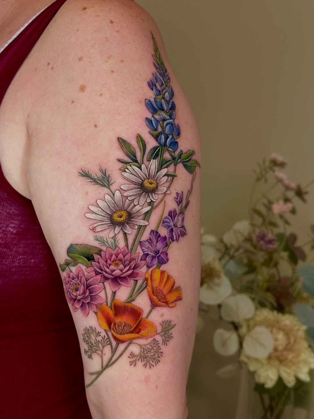Bouquet of wildflowers neo-traditional tattoo on the forearm by Claire