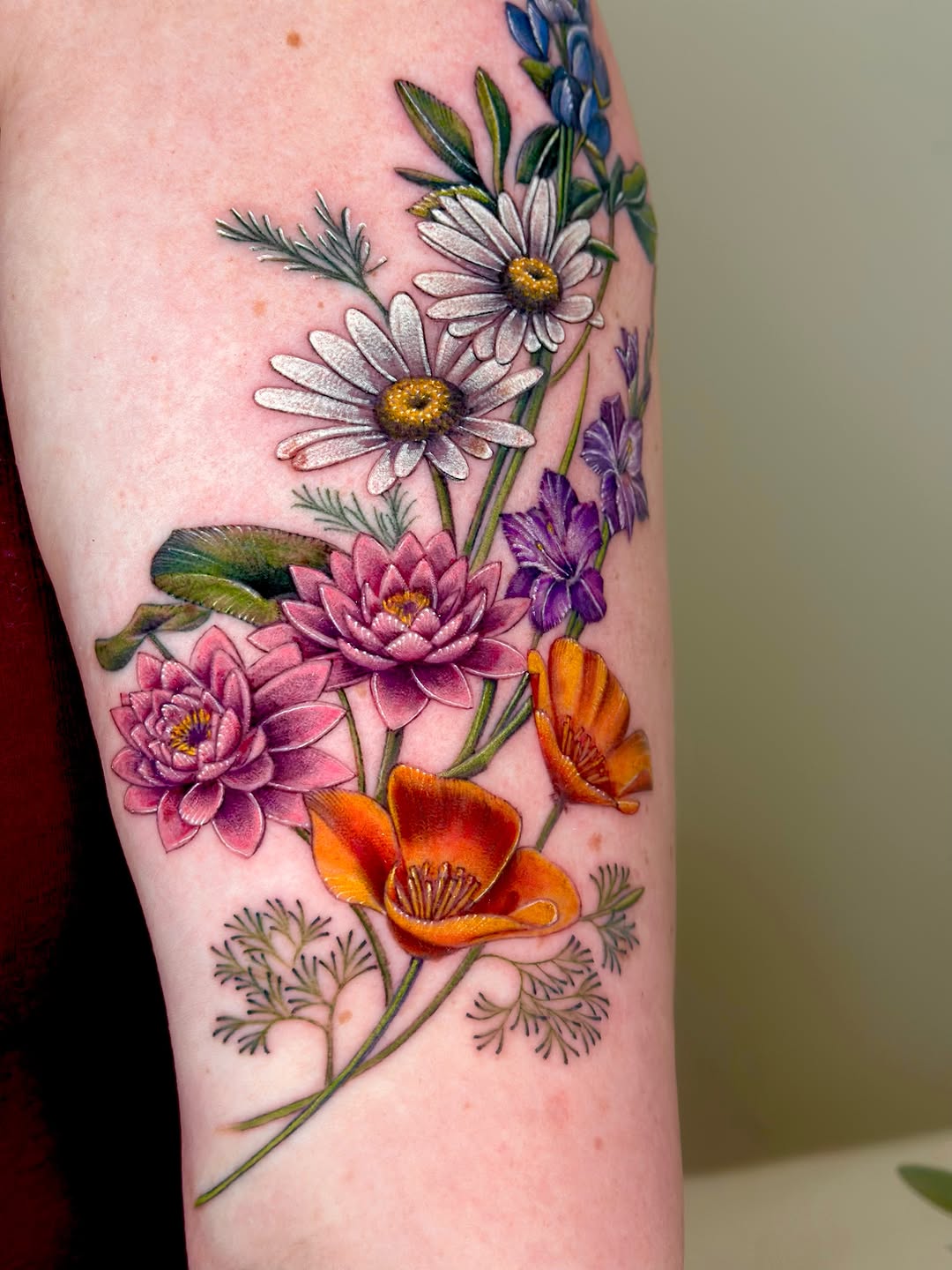Bouquet of wildflowers neo-traditional tattoo on the forearm by Claire