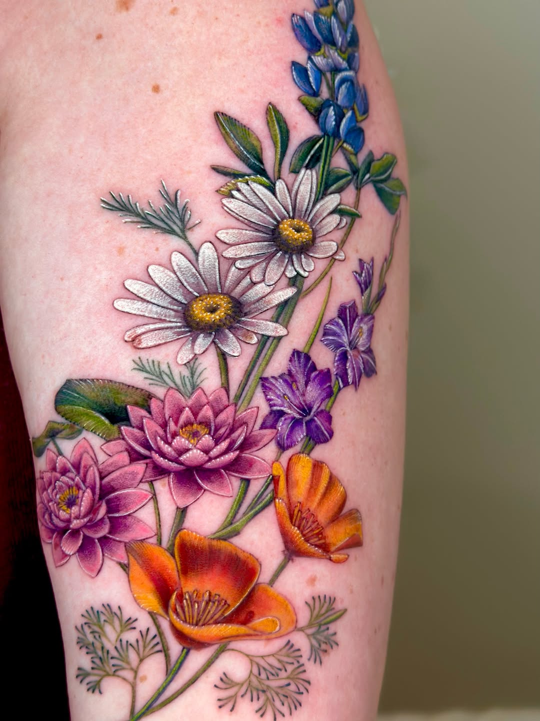 Bouquet of wildflowers neo-traditional tattoo on the thigh by Claire