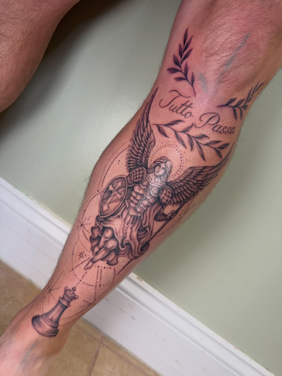 Angel and chess piece realism tattoo on the forearm by Koryn Donnelly