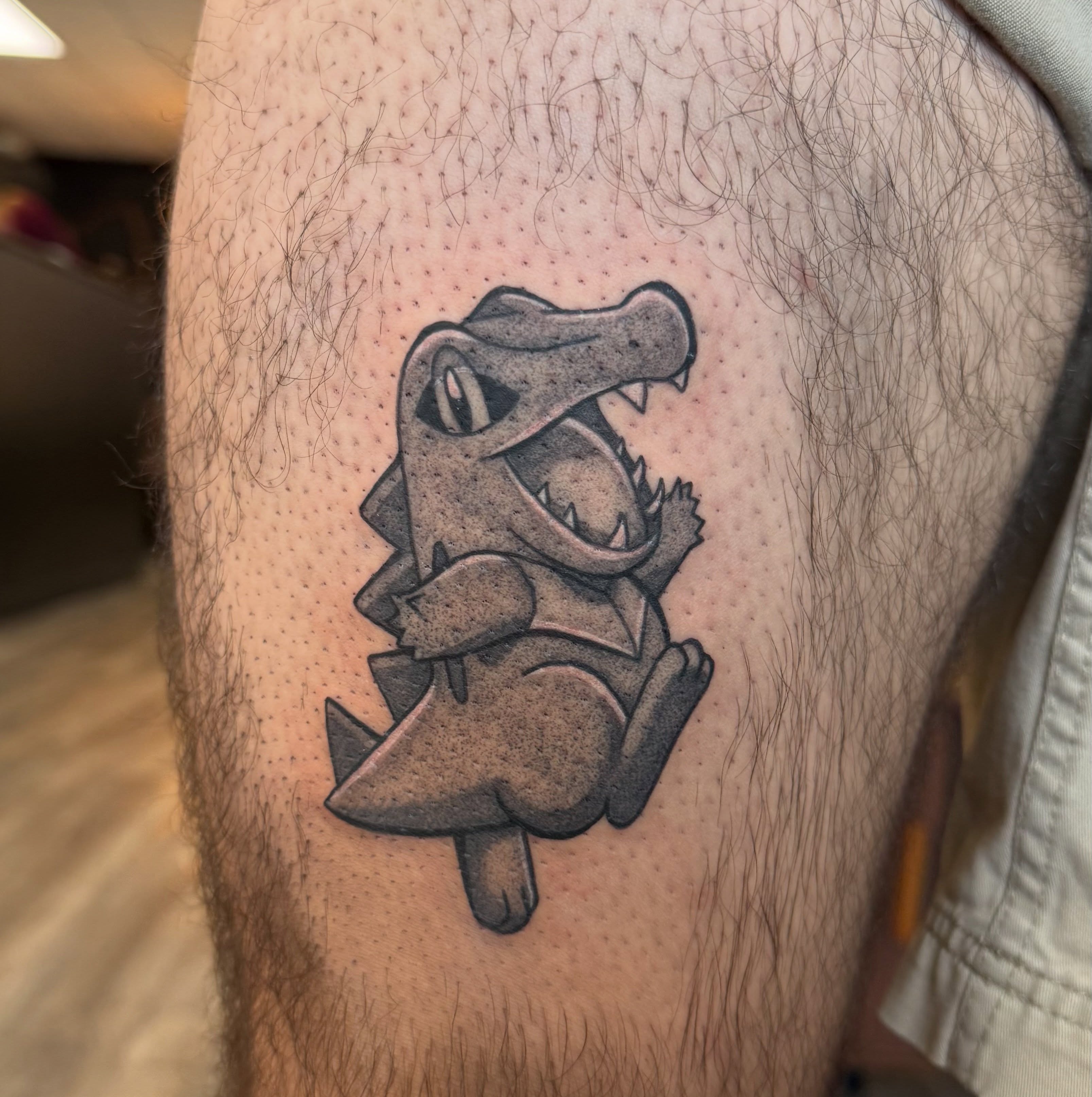 Alligator black and grey tattoo on the thigh by Kate Marie