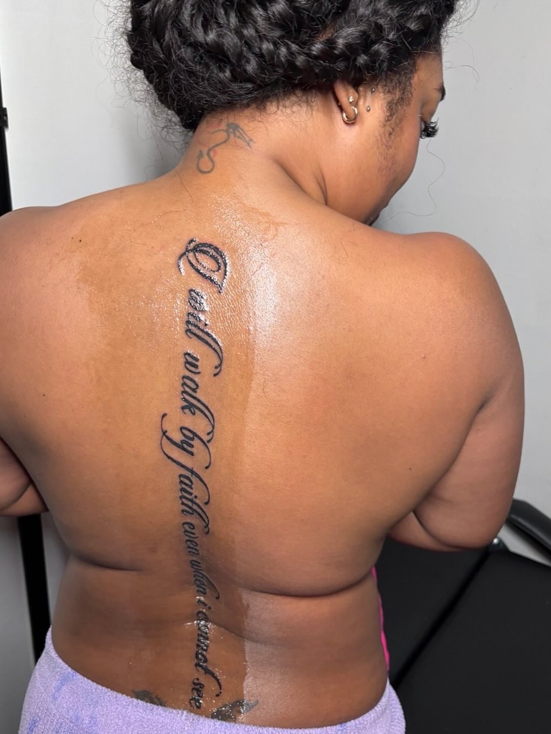 Script lettering lettering script tattoo on the back by K.L Tattoo Uptown