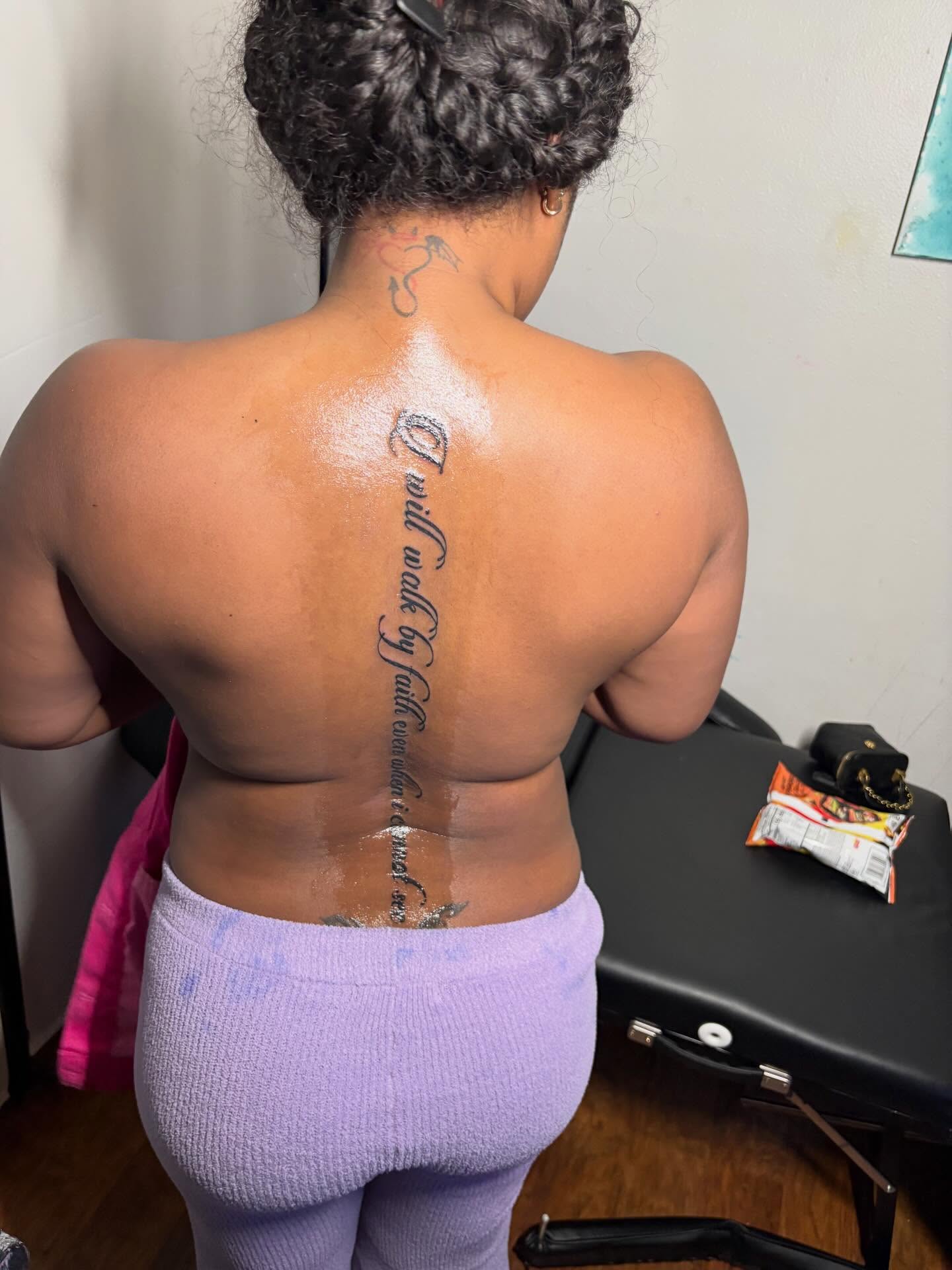 Script lettering lettering script tattoo on the back by K.L Tattoo Uptown